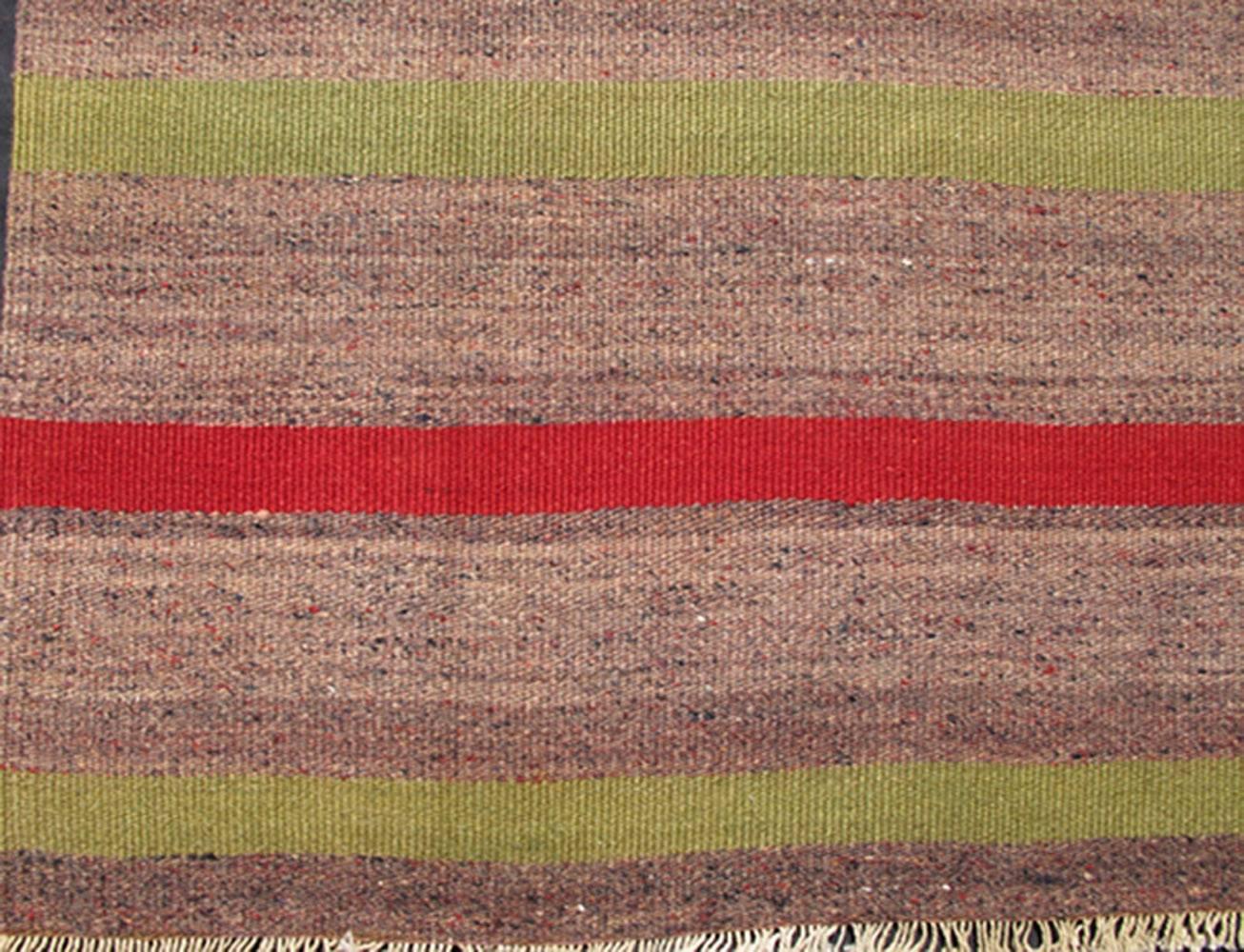 Turkish Kilim Vintage Carpet in Red and Green Stripes
rug/tu-ned-37,  origin/turkey

This vintage Kilim carpet from Mid-Century Turkey features a stripe pattern set atop a mocha and taupe background. Colors include red and light green.
Measures: