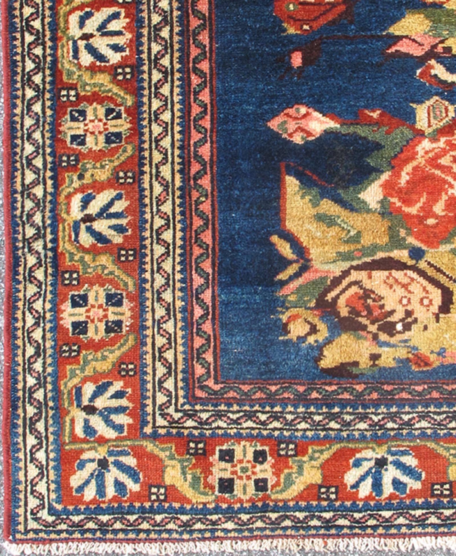 Persian Malayer Carpet with Large Flowers on Deep Blue Field
rug/13-0609, origin/iran

This magnificent antique Persian Malayer carpet bears a beautiful, all-over floral design paired with a delightful palette of various shades of deep blue, red,