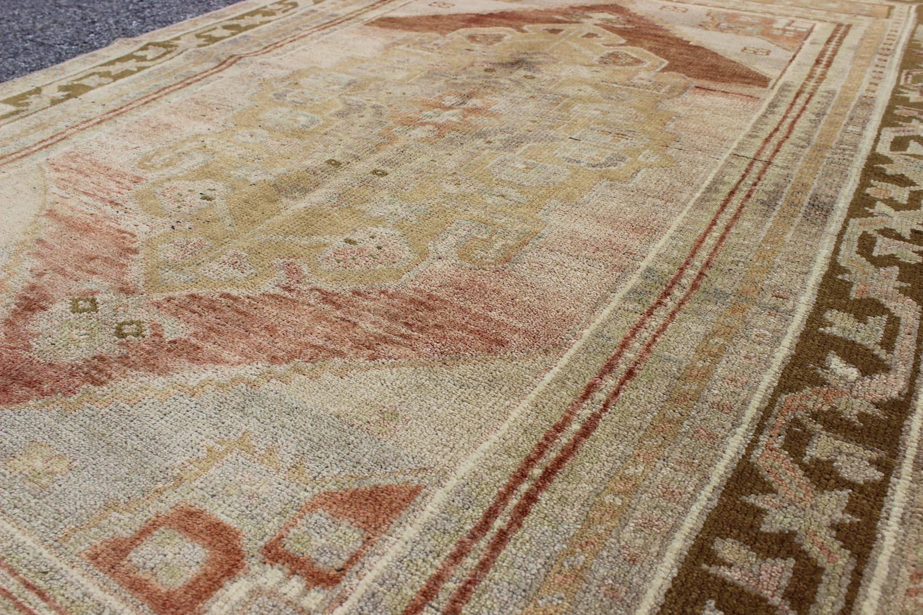 Wool Vintage Turkish Oushak with Large Central Medallion in Cream, Yellow, Brown and  For Sale