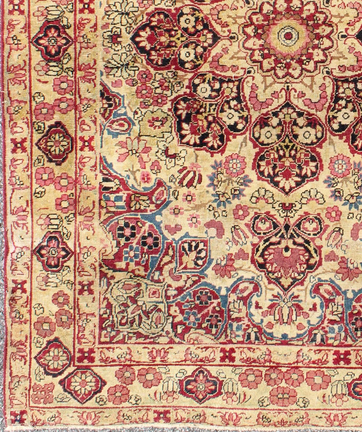 Late 19th century antique Lavar-Kerman rug with red and pink floral medallion, rug j10-1003, country of origin / type: Iran / Kerman, circa 1890

This antique Persian Lavar Kerman rug, circa 1890 from the late 19th century features an ivory field,