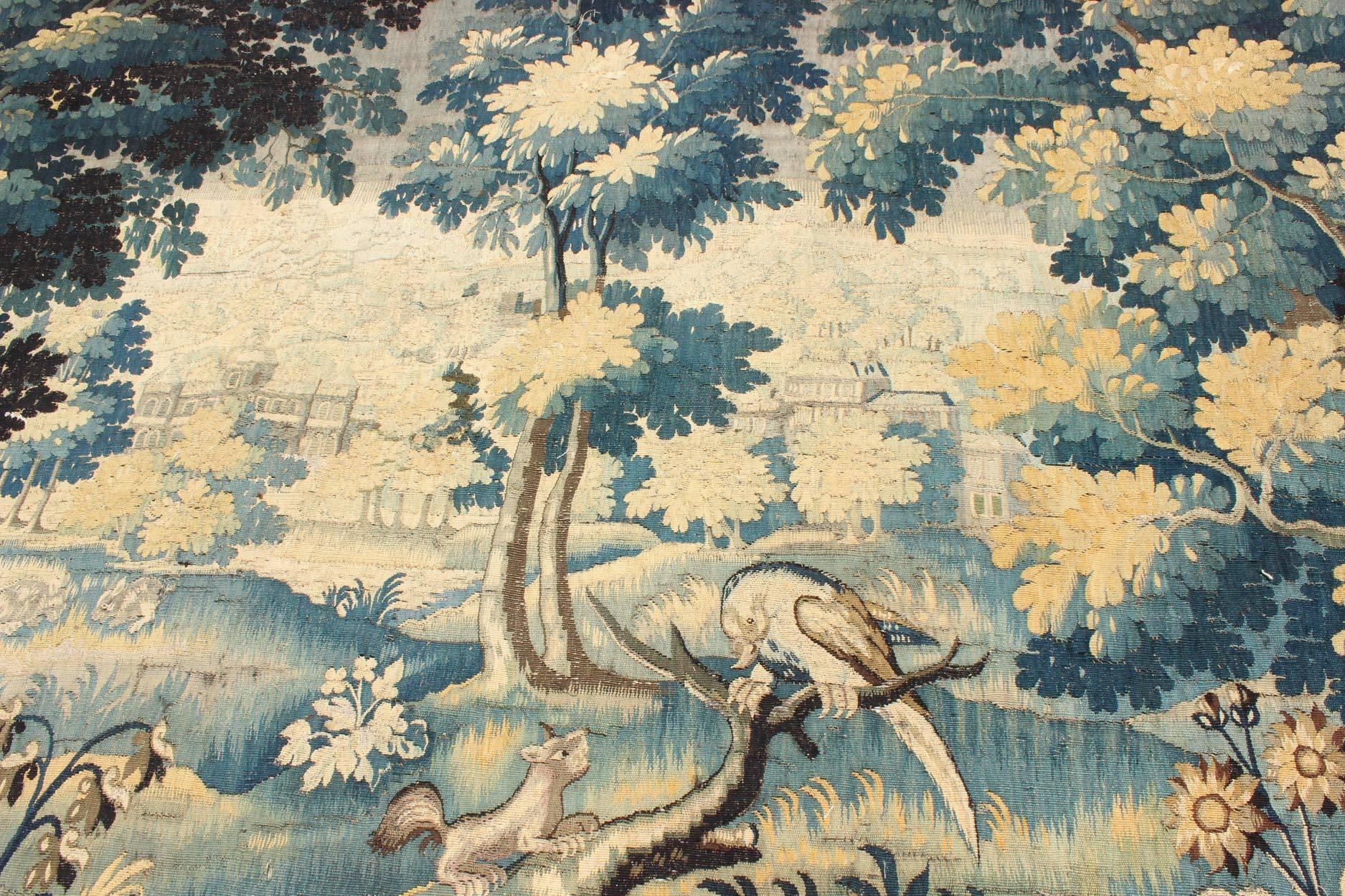 17th Century Antique Tapestry with Woodland Scene and Floral Border in Blue Tone In Good Condition For Sale In Atlanta, GA