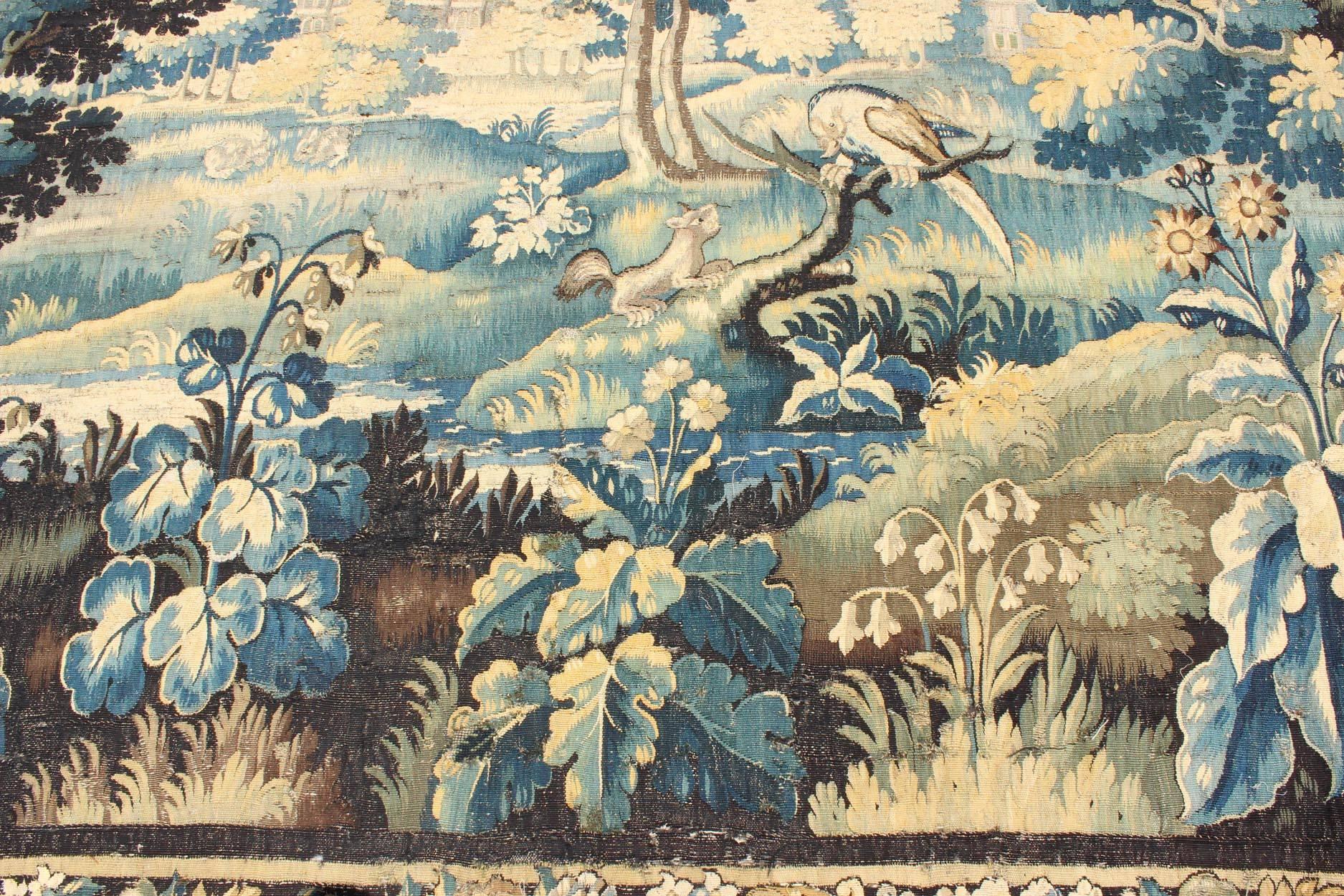 Wool 17th Century Antique Tapestry with Woodland Scene and Floral Border in Blue Tone For Sale