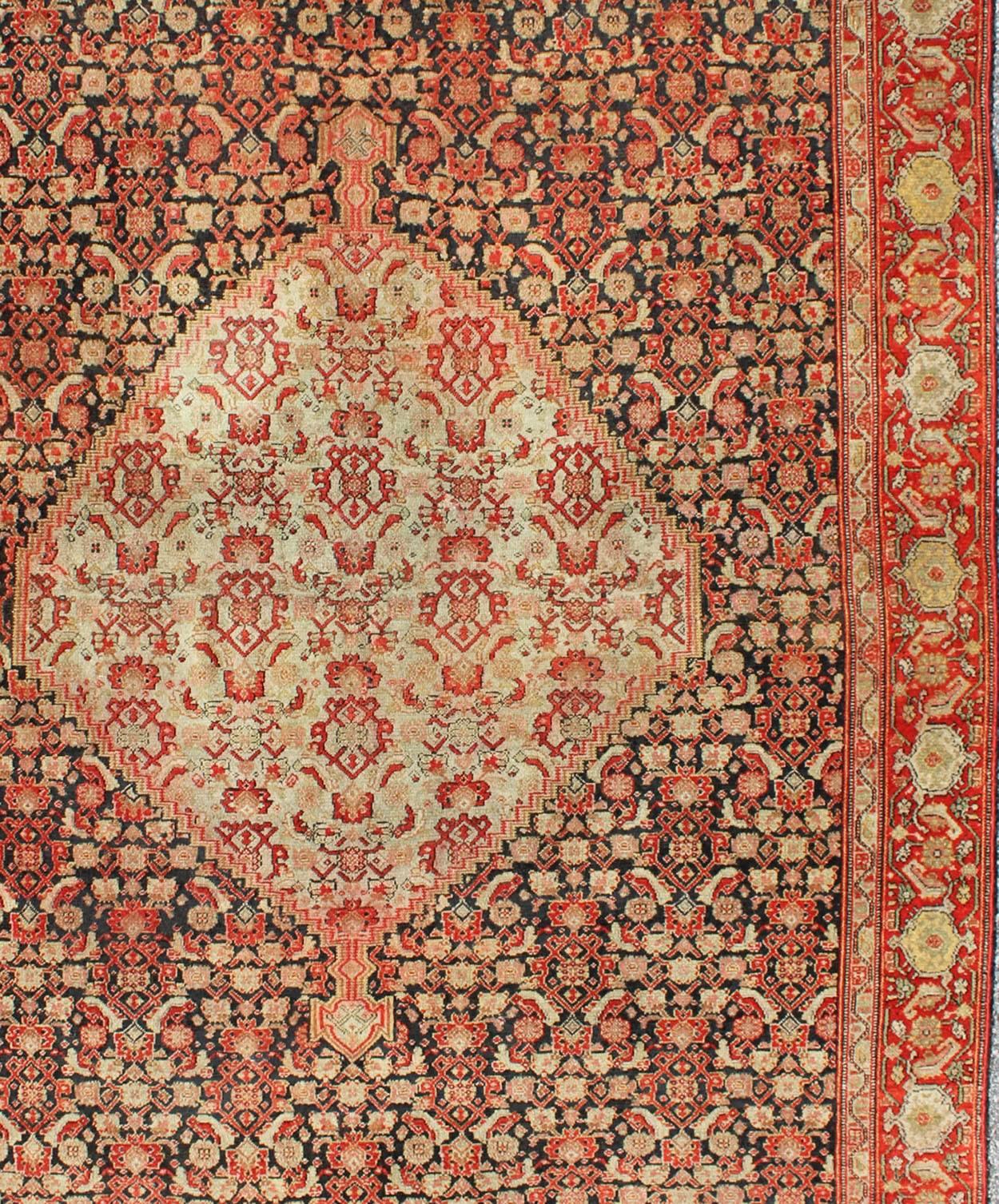Hand-Knotted Antique Persian Senneh Rug with Unique Medallion and All-Over Design For Sale