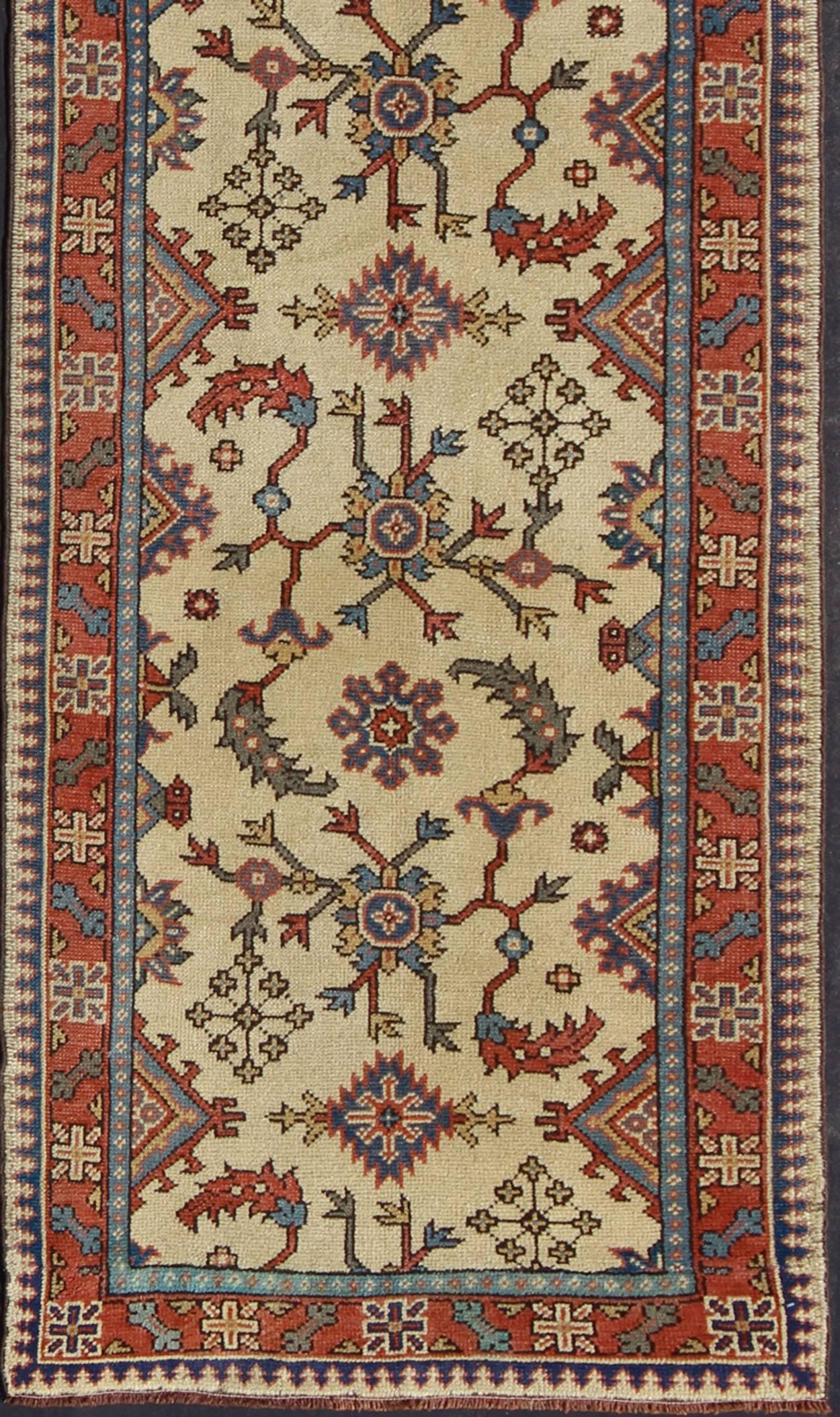 Very long Turkish Oushak runner with all-over floral design in cream, coral and blue, rug / TU-MTU-4627, country of origin / type: Turkey / Oushak, circa early-20th century

This long antique Turkish Oushak runner (circa 1930) is remarkably