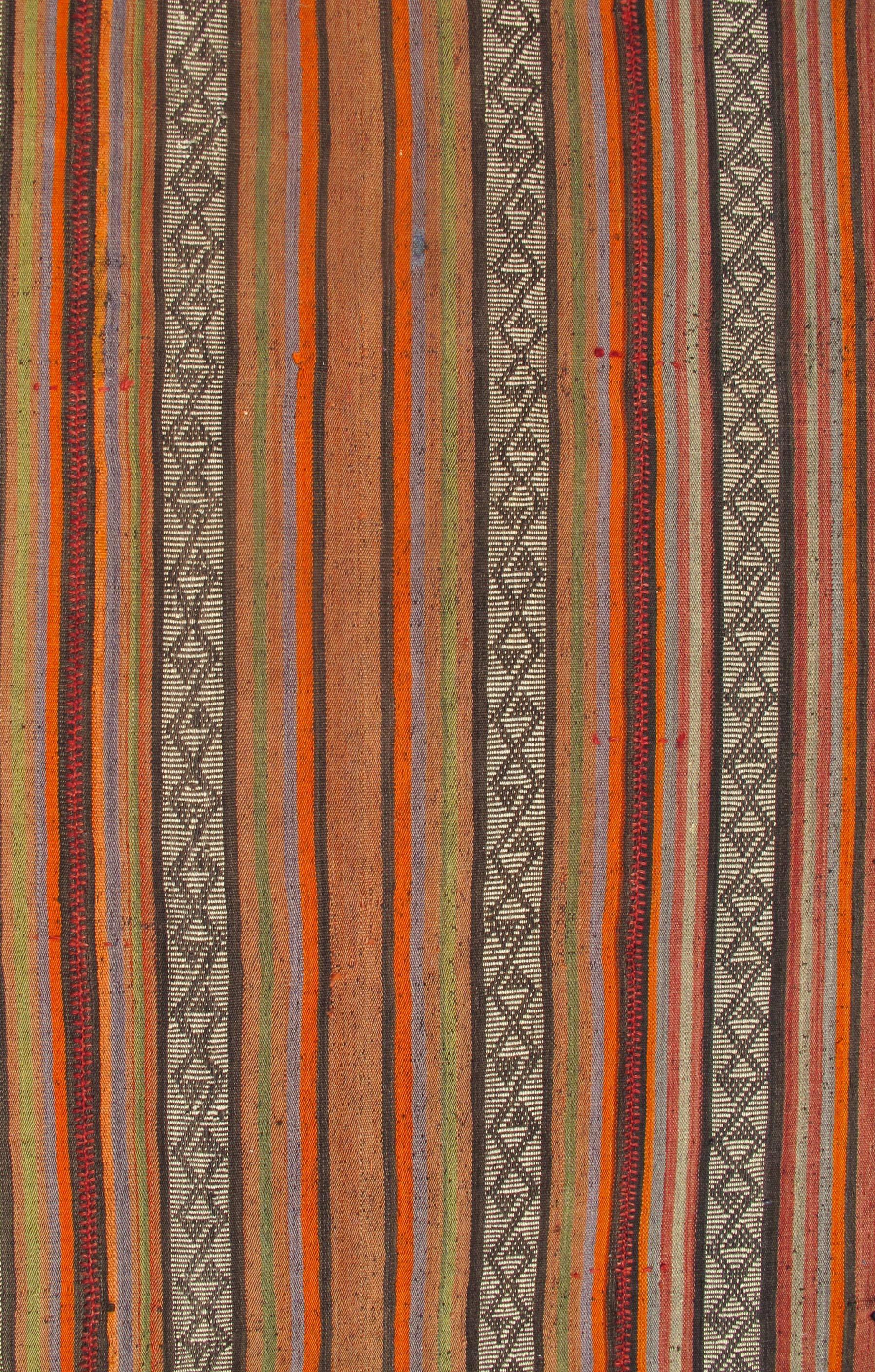 Colorful long Turkish Kilim Runner with vertical stripe and geometric pattern, rug ned-136027, country of origin / type: Turkey / Kilim, circa mid-20th century.

Woven during the mid-20th century in Turkey, this designer Kilim is decorated with a