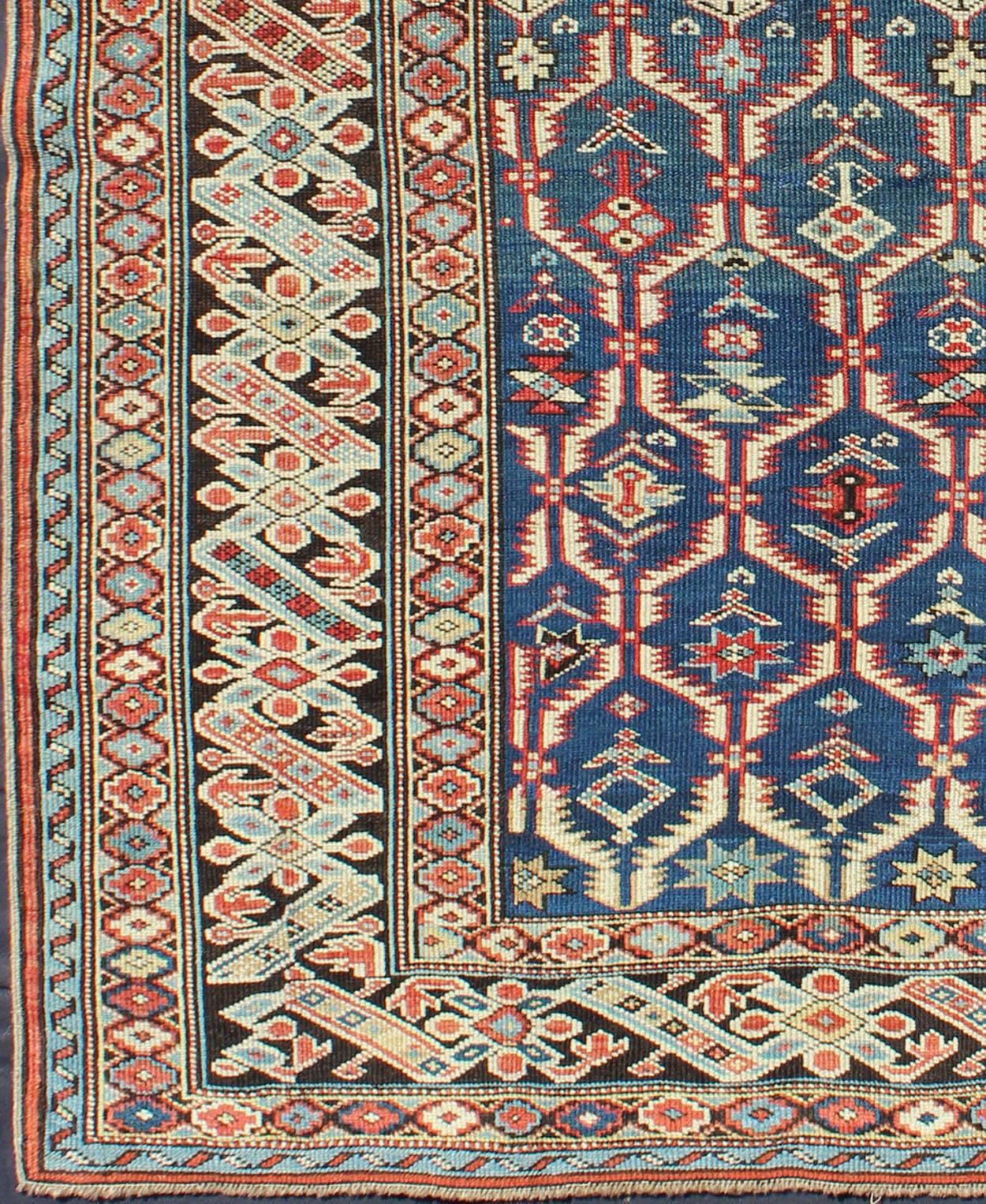 Measures: 3'6 x 4'10.
This Gorgeous 19th Century Chi Chi rug displays an amazing color combination of medium blue, Green, Brown and rust colors, featuring a repeating symmetrical patterning, enclosed by wonderful complementary borders.

 Antique