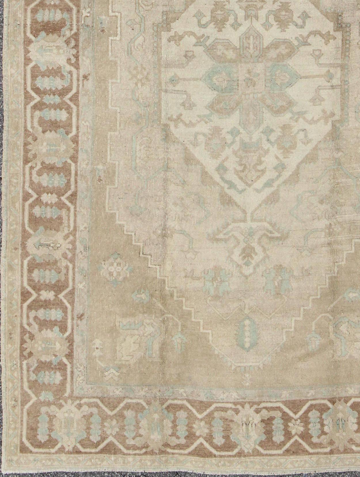       Vintage Oushak Medallion Rug With Muted Colors and Earth Tones. Keivan Woven Arts / rug EN-951, country of origin / type: Turkey / Oushak, circa 1950.

This striking vintage Turkish Oushak rug bears an cream-colored body that is highlighted by