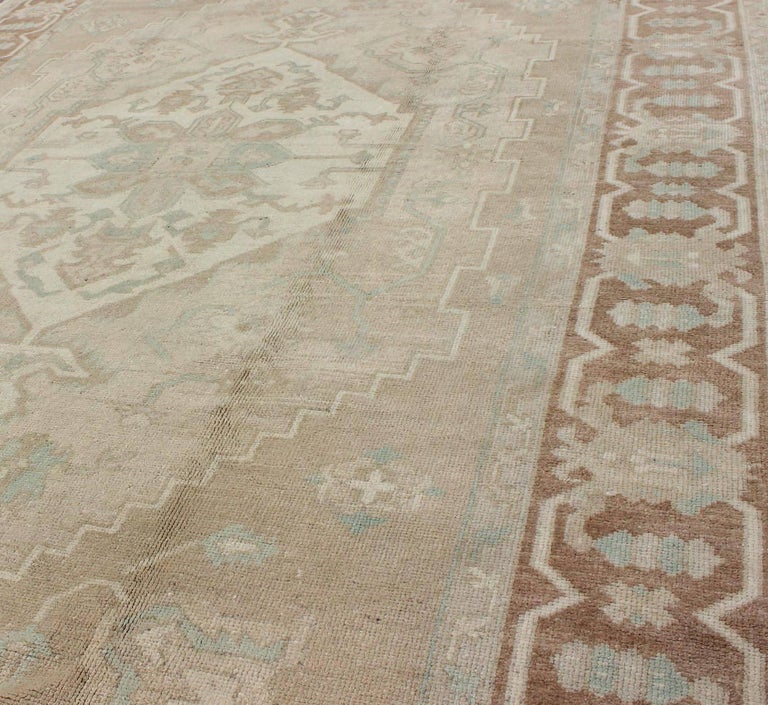 Vintage Oushak Rug with Muted Colors and Earth Tones For Sale at 1stDibs