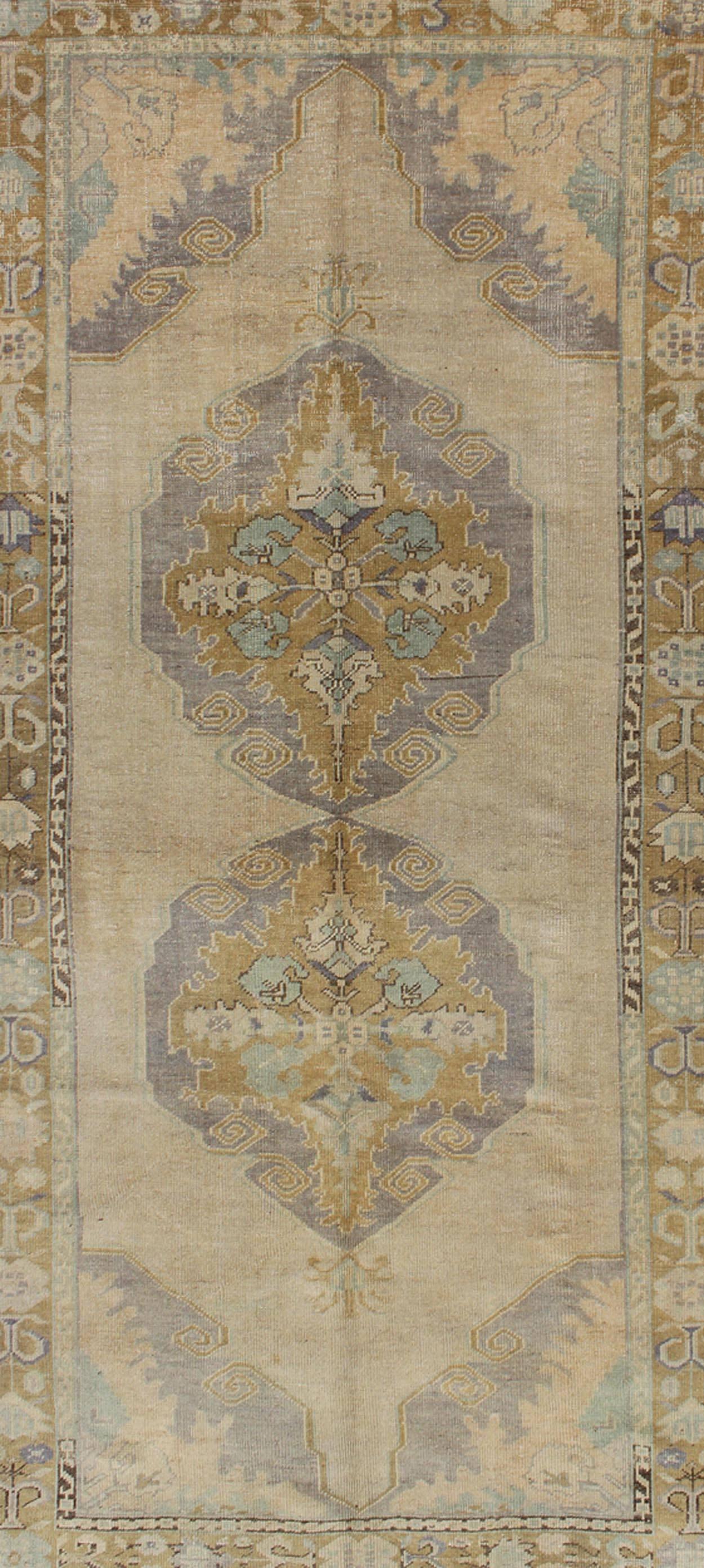 Turkish Vintage Gallery Oushak Rug With Floral Medallions in Earthy Tones and Lavender For Sale