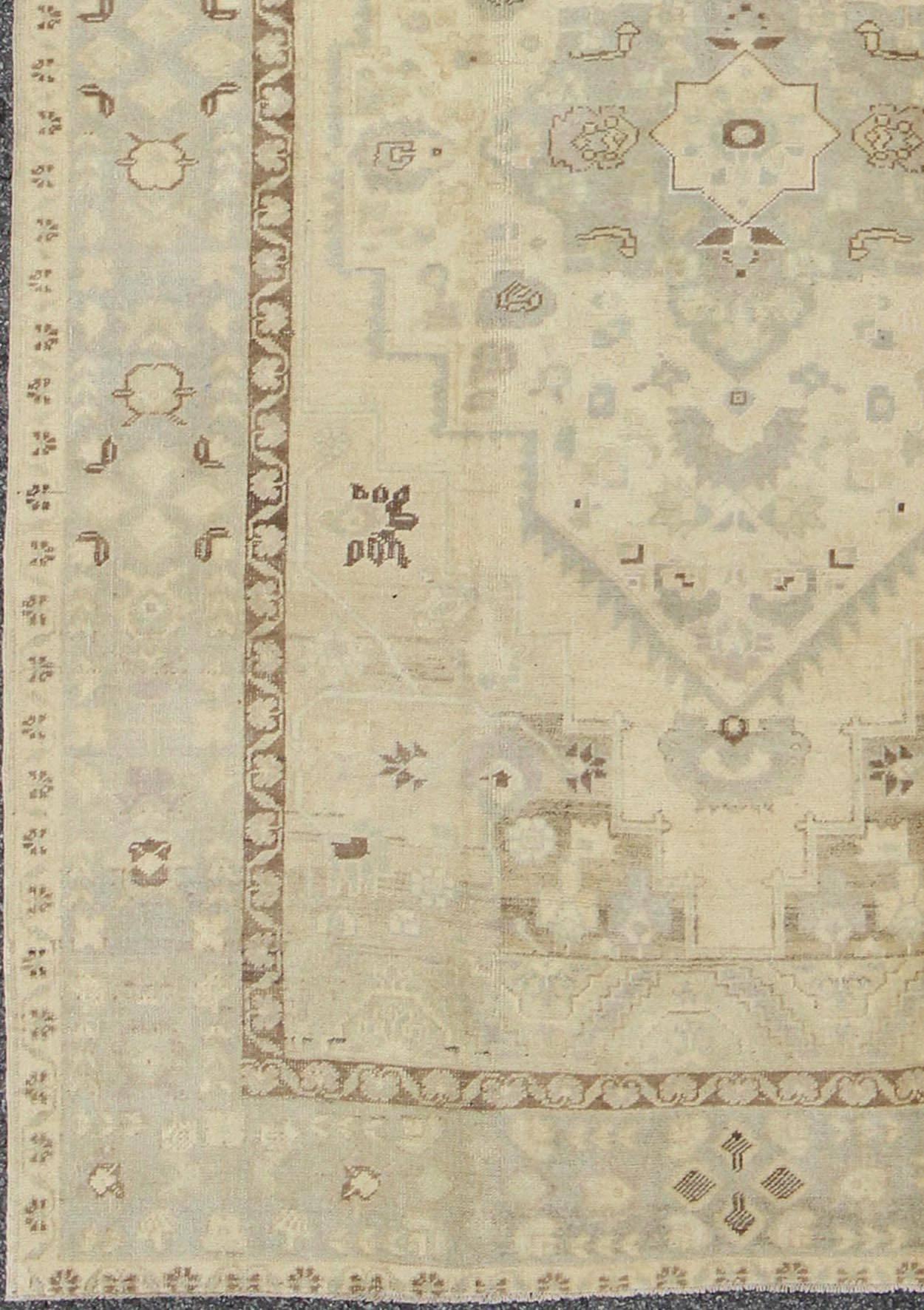 Vintage Turkish Oushak Rug in Butter, Cream, warm gray, Brown

Measures: 6'4 x 9'4

This stunning vintage Oushak displays a warm gray border and cream, butter, taupe background with brown highlights. The bold geometric design is softened by the use