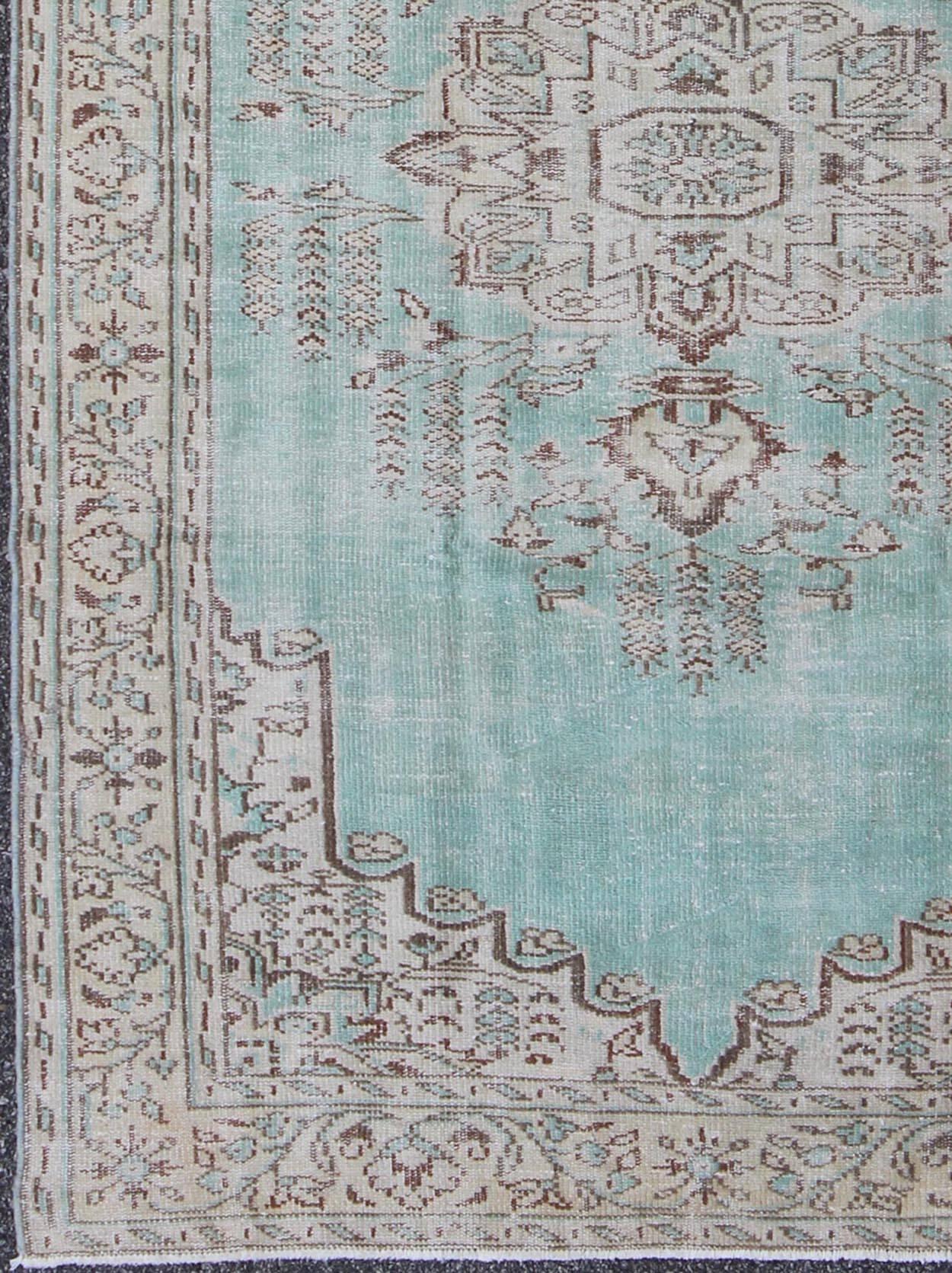 Vintage Oushak Rug with Aqua Color Background and Brown Highlights.
This Turkish Oushak rug displays a unique aqua blue as the main color background. Other colors include brown and light taupe. The bold and geometric design of this Turkish carpet is