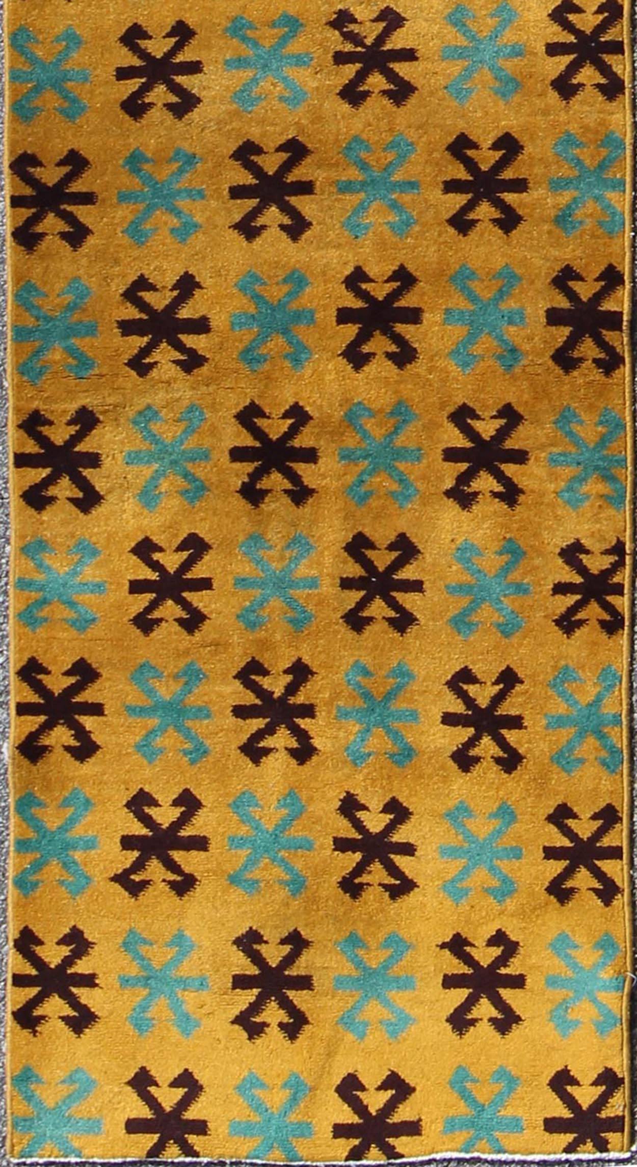 Measures: 2'7 x 13'9.
This artfully handwoven Turkish mid century design runner displays a unique geometric design and color combination, featuring yellow background and repeating teal/Turquoise and black motifs, rendering this piece finely suited