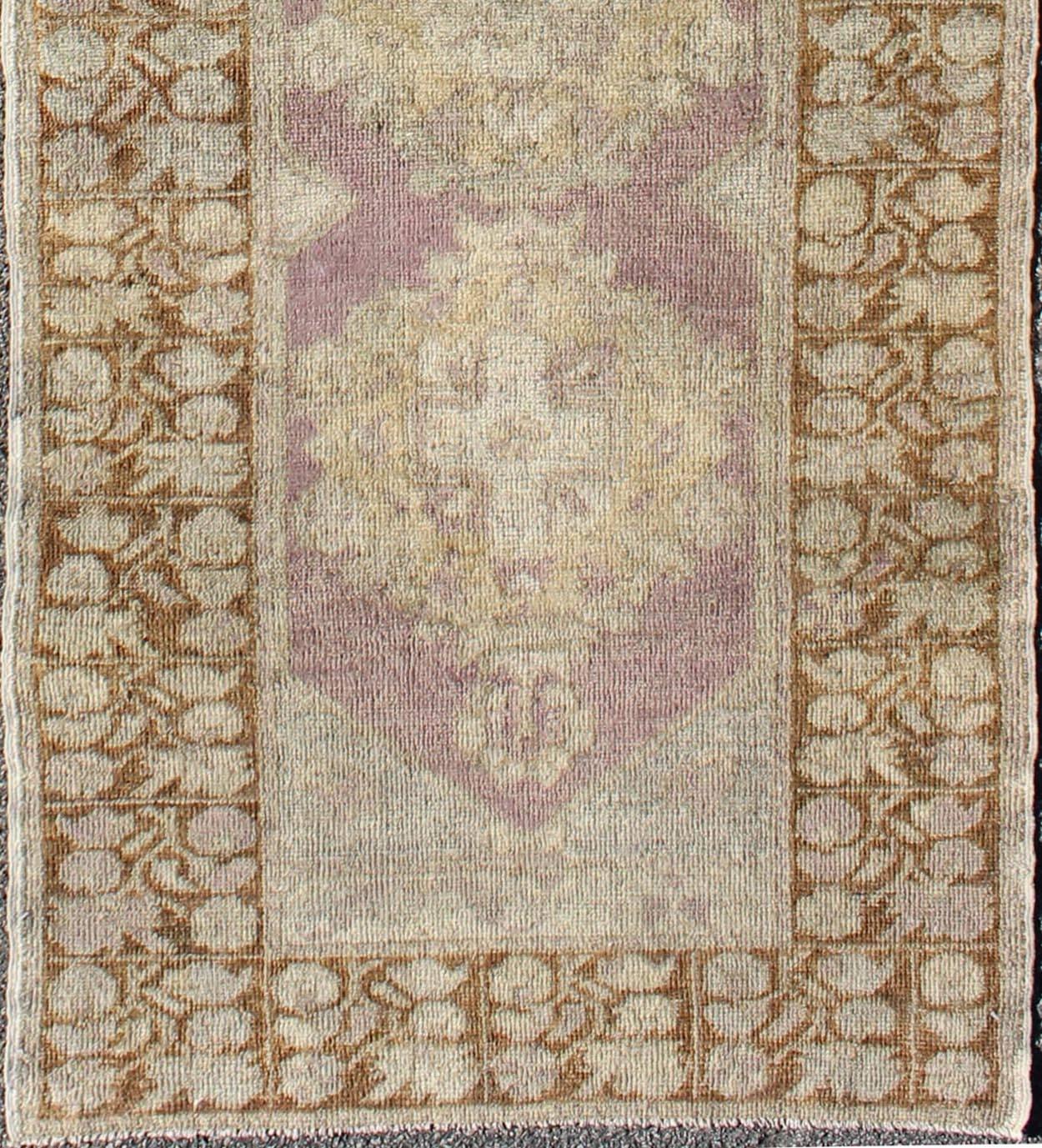 This unique Turkish Oushak runner displays an elegant multi floral medallions which are complemented by a sub-geometric border. This rug has light purple background with dark brown, light blue, cream, green and taupe.

Measures: 3'1'' x