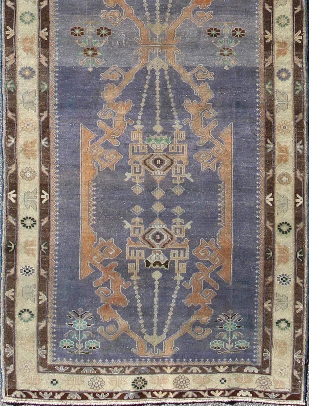 Long Vintage Sivas Runner in Elegant Purple and Brown
Bold in design and delicate in colors, this very unique long Turkish Sivas runner rests on a light purple background with three medallions in the center. An ivory main border and two smaller