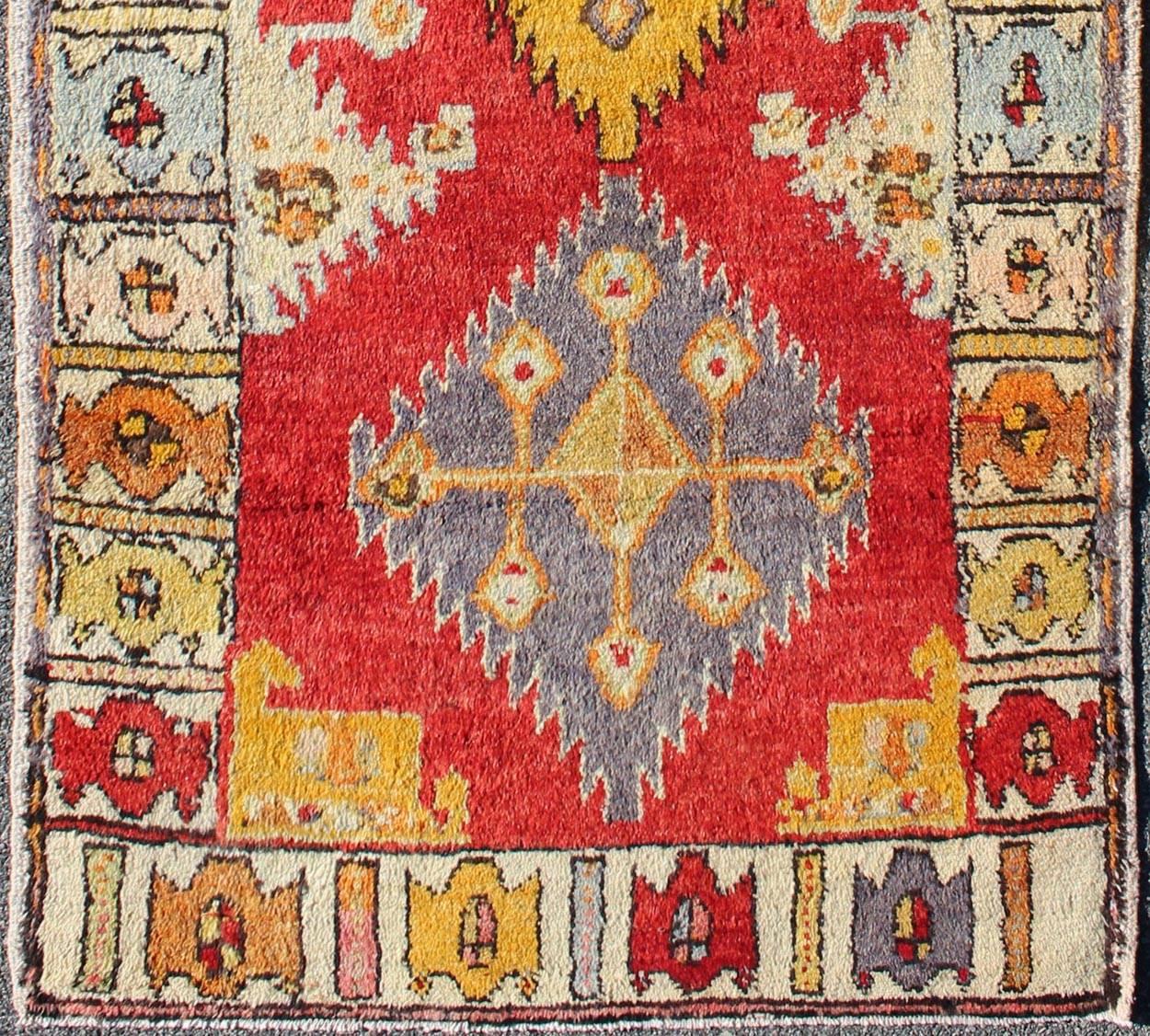 Tribal Turkish Oushak Runner with bright colors in Red, Gold, Yellow and Orange.
This cheerful Oushak runner contains a unique blend of colors along with geometric design. The multi-layered diamond medallions are complemented by asymmetrical and