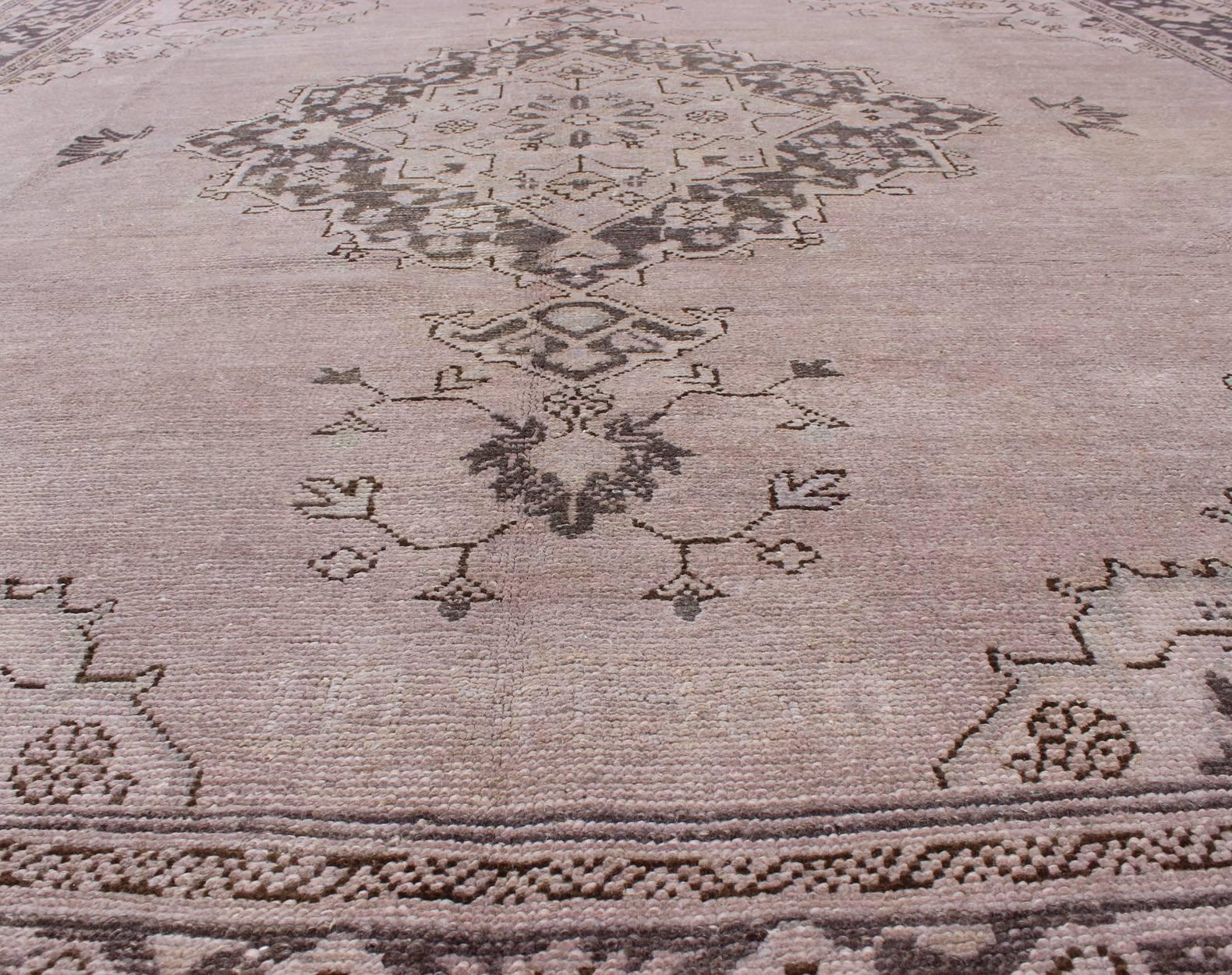 Early 20th Century Antique Oushak With Medallion design in Lavender, Charcoal Brown, pale blue  For Sale