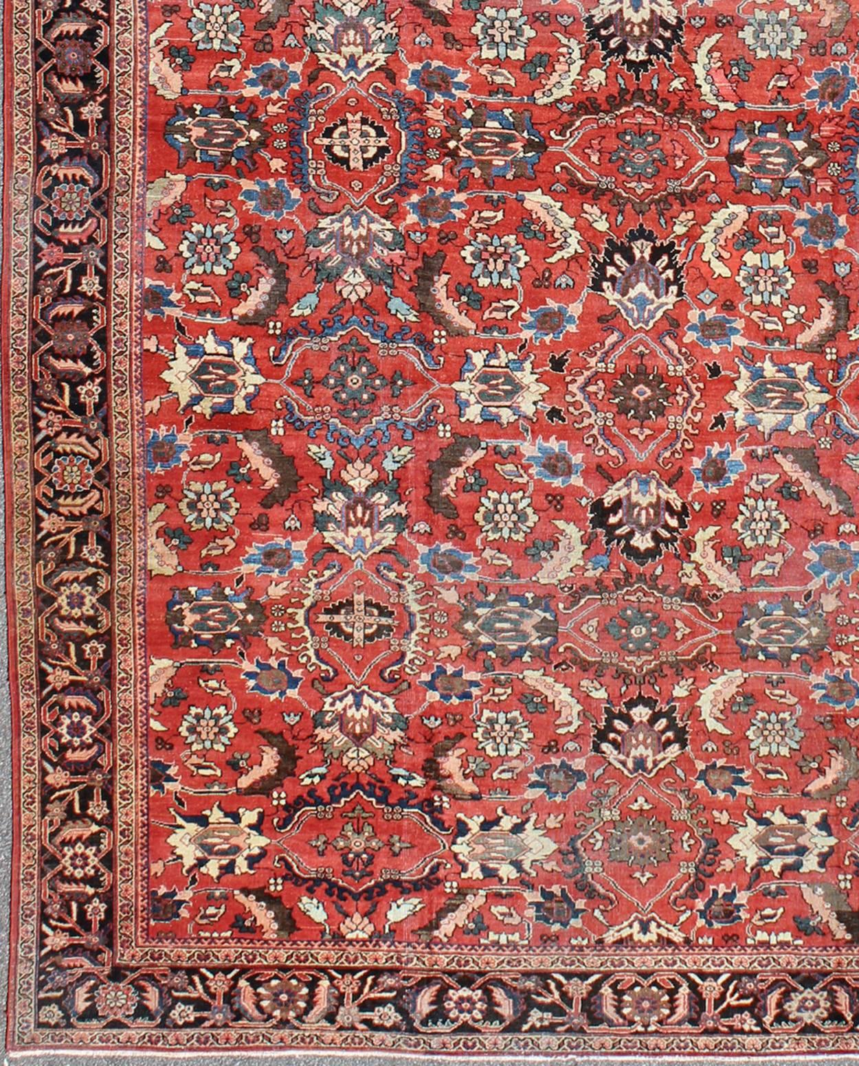 Very Large Persian Sultanabad Mahal Rug in Red, Brown, Green, Cream & Blue.
This Sultanabad relies heavily on exquisite details as well as large-scale palmettes. A fine trellis of richly colored large and small flowers sprawls across the soft red