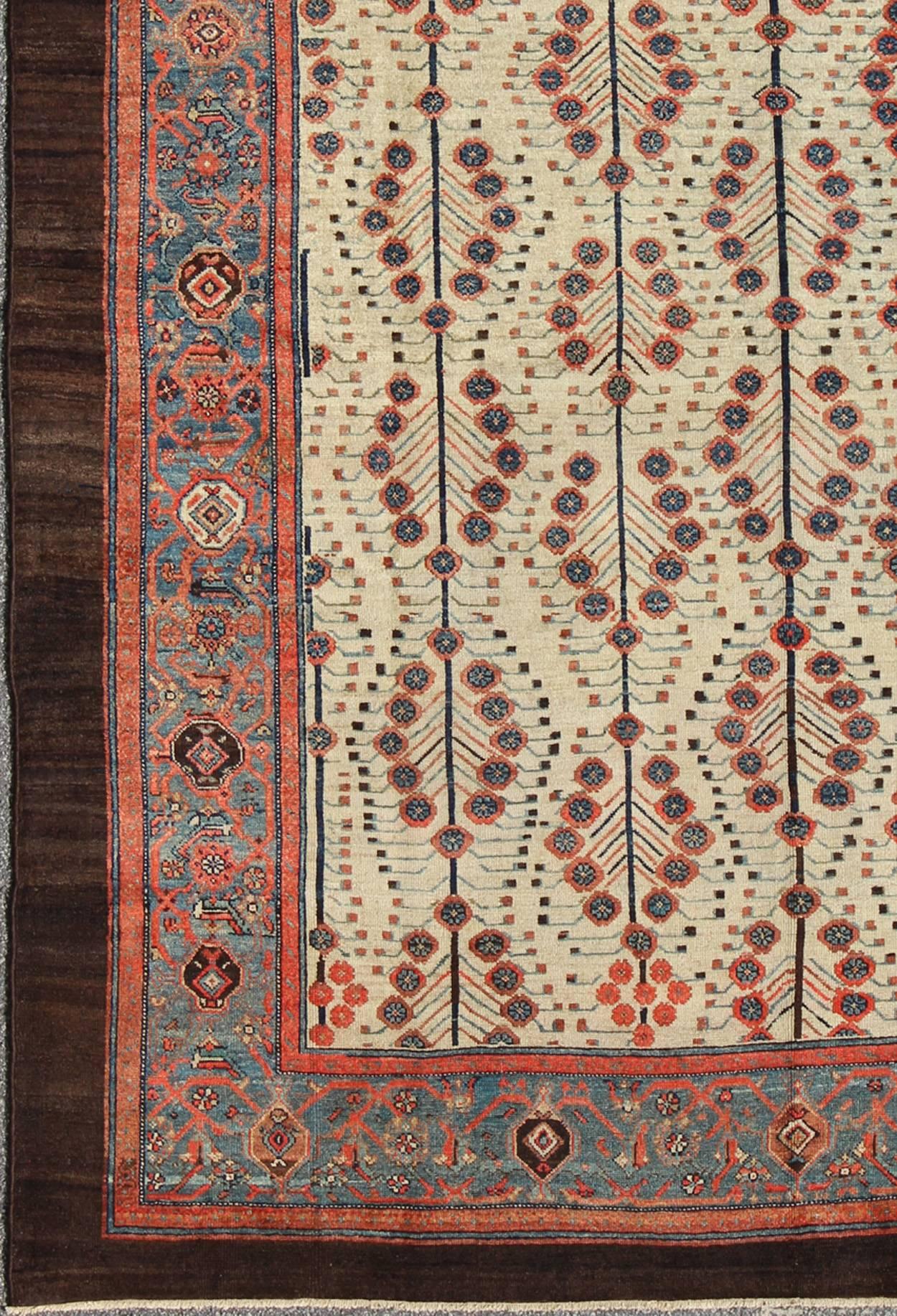 Antique Persian Serab Rug with a Bakhshaish Tree Design in Cream, Red, Blue and Brown Colors.
This amazing antique Persian Serab/Bakhshaish rug is a masterful example of the Serab rugs of the late 19th Century. Early Serab rugs are prized for their