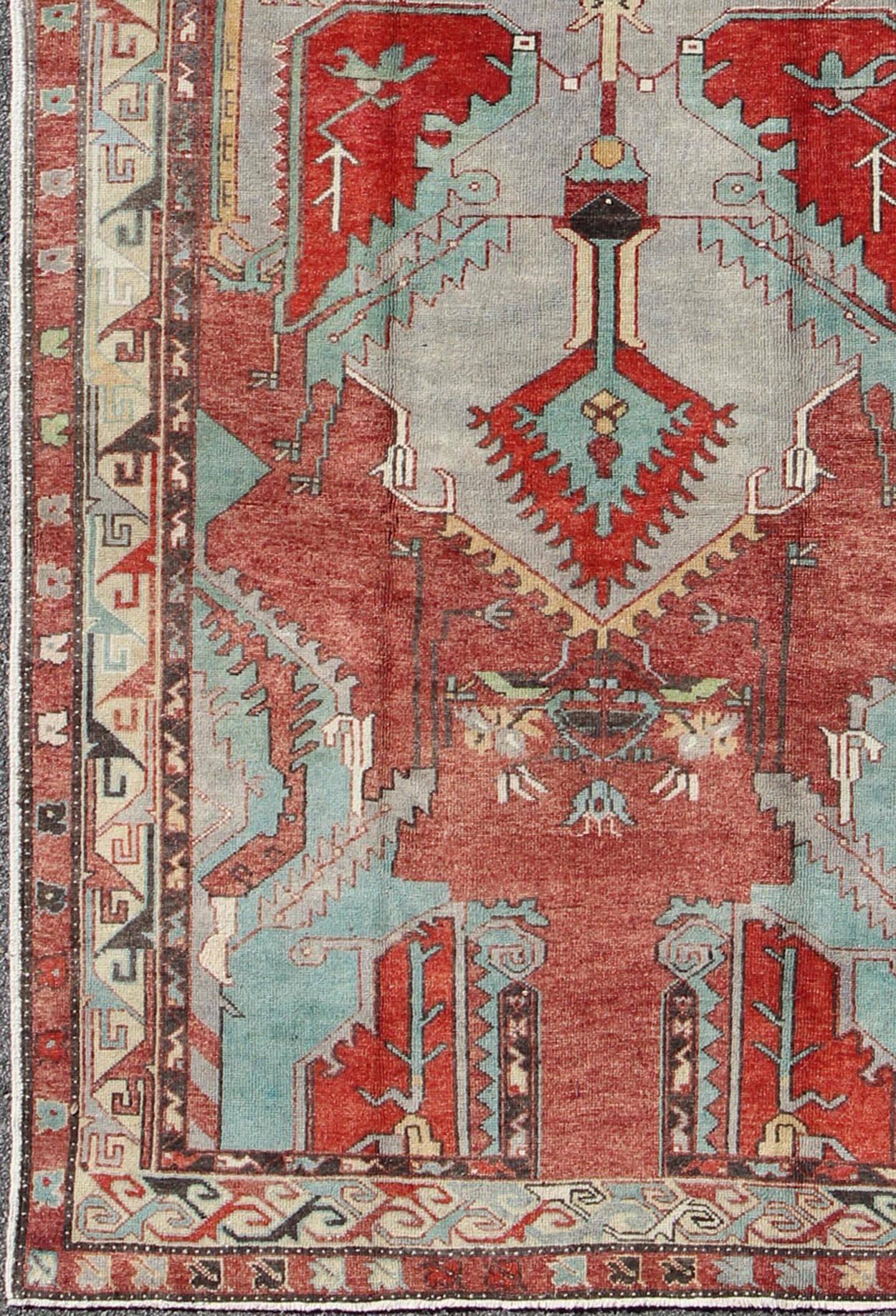 Vintage Turkish Oushak Gallery Rug with Geometric Design.
This Turkish Oushak gallery runner features subtle tones of Reds, taupe, beige, soft green, and light teal, which are highlighted by chocolate and mocha colors. The stylized center medallions