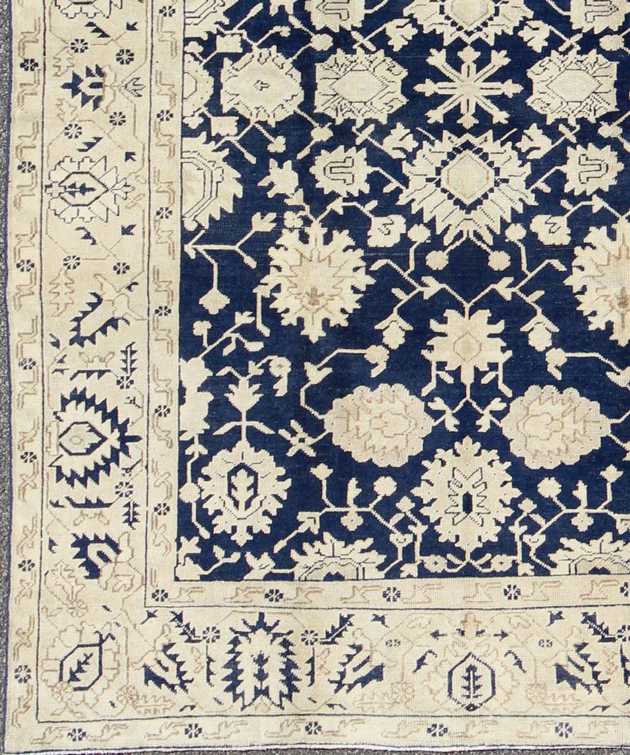 Unique Turkish Oushak Rug with all over Floral Design in Dark Blue, Cream and Light Brown rug/TU-MTU-3610
This unique Oushak rug features all-over geometric and floral abstractions, serrated leaves, and arabesques on a navy blue field. Angular