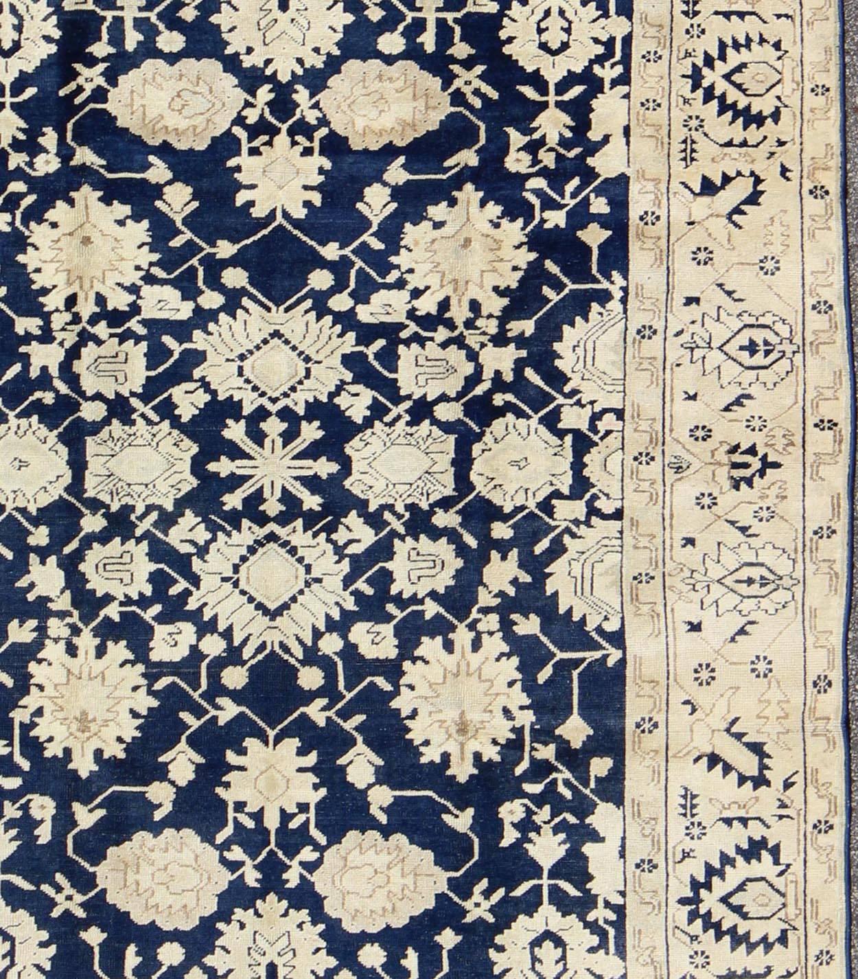 Hand-Knotted Unique Turkish Oushak Rug with Floral Design in Dark Blue, Cream and Light Brown For Sale
