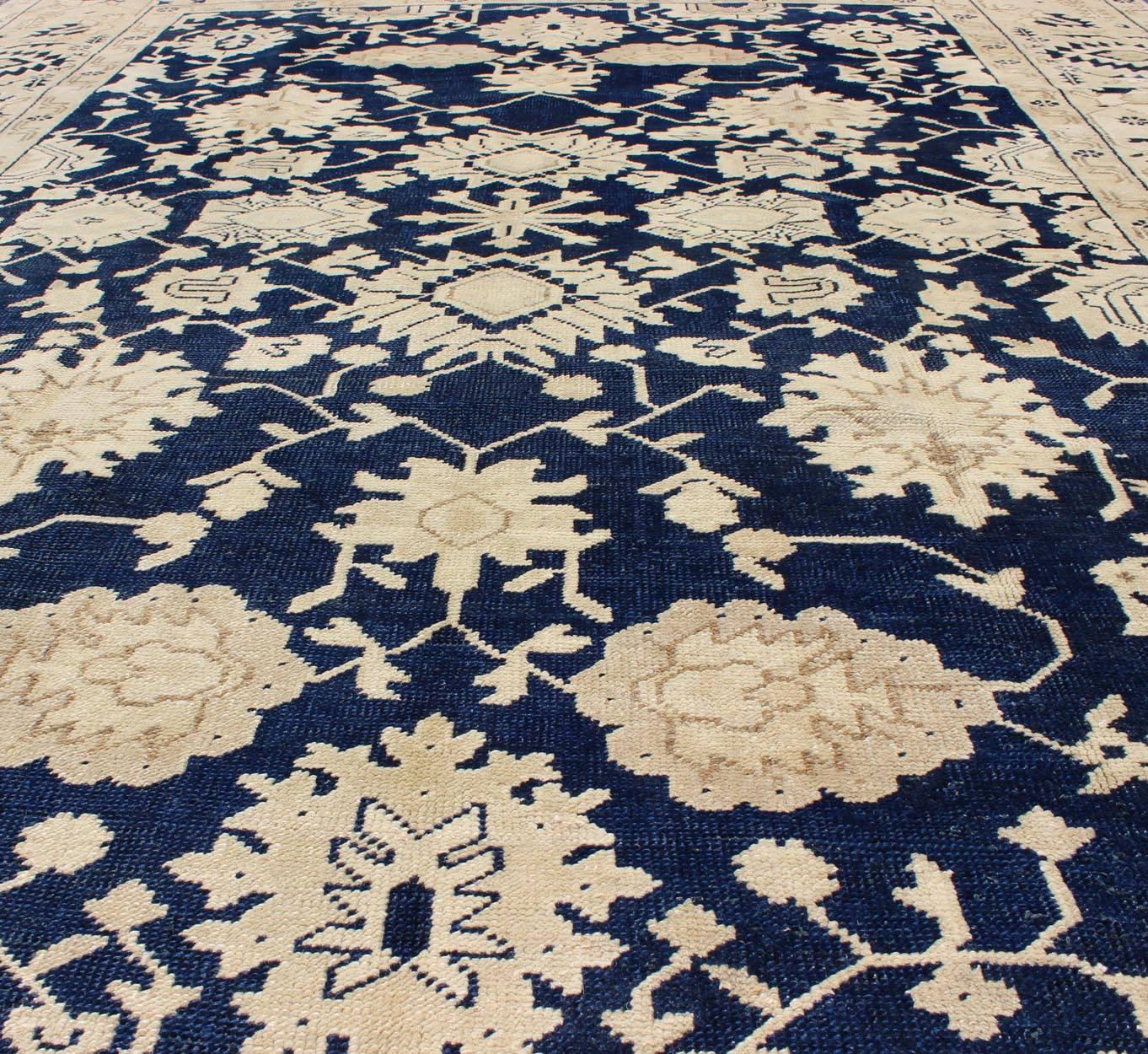 20th Century Unique Turkish Oushak Rug with Floral Design in Dark Blue, Cream and Light Brown For Sale