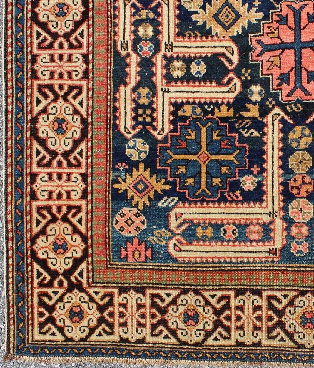 The archetypal motifs in this piece are accompanied by a tower of stacked polygons with small V-shaped indentations, a Karaghashli rug hallmark. Each decorative foil is embellished with eight-armed brackets and tiny lozenge-shaped accents. Isolated
