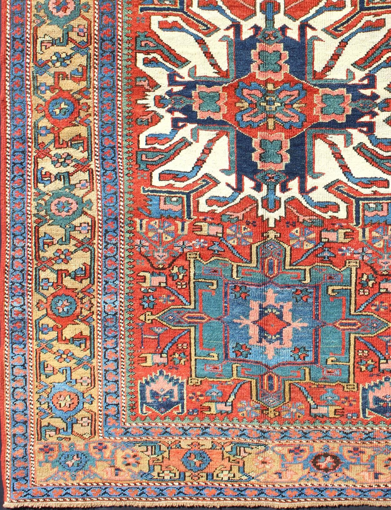  Measures: 4'7'' x 6'10''.
Established with luxurious jewel tones, this finely woven antique Serapi-Karajeh carpet from Persia is a striking piece. It is engagingly accented with a brilliant tangerine tone, which play off of the cool-toned
