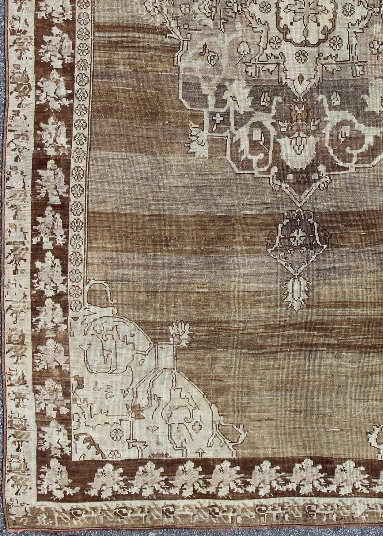 Unique Turkish Kars Carpet in Brown, Gray and Ivory
This striking and unique carpet combines a traditional center field with an Art Deco border and features a color palette including brown, cream, Gray and ivory.
Measures: 8'0 x 12'5.