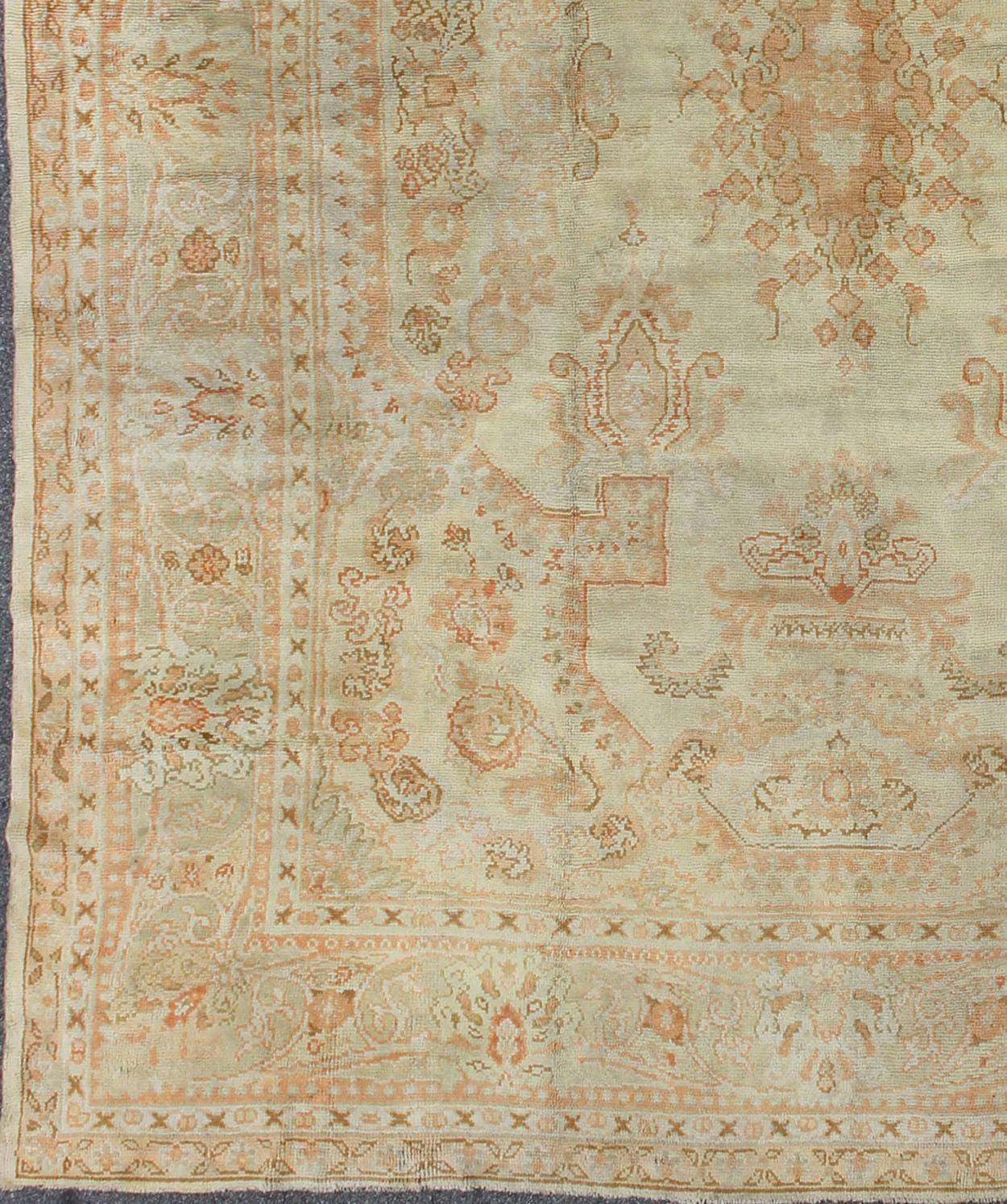 Large Antique Oushak Carpet in Ivory Background, Taupe, Gray , Green and Salmon.
This remarkable antique Oushak displays an elegant design and a fabulous, soft color palette. The intricate border is a subtle gray-green, and the background is neutral