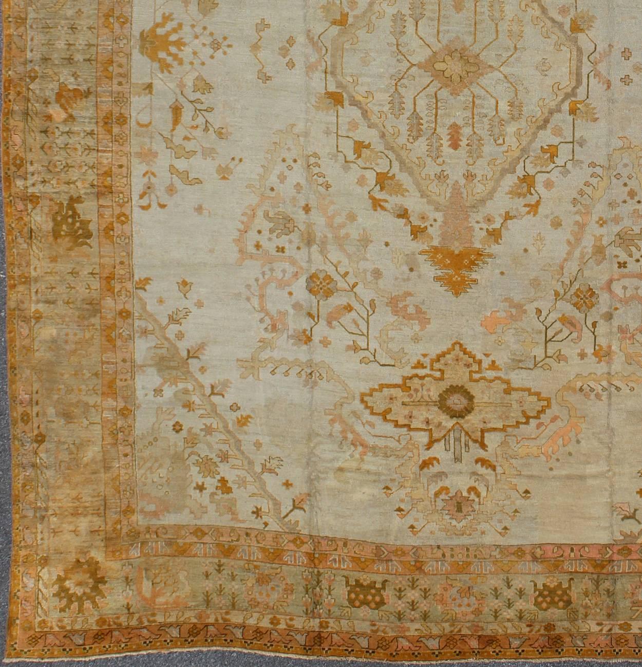 Remarkable Large Antique Turkish Oushak Carpet in silver/Ivory, gold, light green, taupe, Salmon,  yellow and orange, Rug/VR-7984

Measures: 16'7 x 21'7

The grand scale of this magnificent palace-sized antique Oushak is tempered only by its