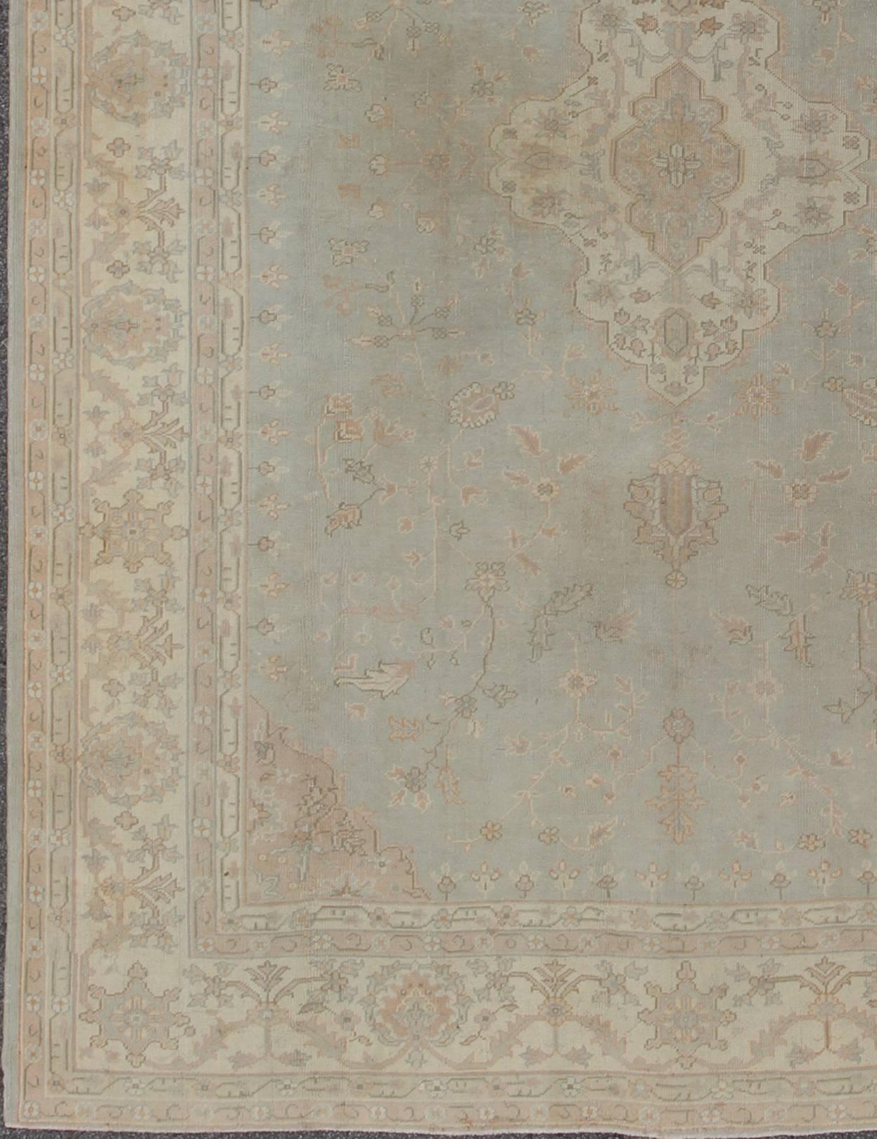 Antique Oushak carpet in pale gray blue, taupe, pink, ivory and light salmon. Keivan Woven Arts / rug IS-169, country of origin / type: Turkey / Oushak, circa 1920. 
Measures: 10' X 13'2.
This antique Oushak bears a refined beauty due to its soft