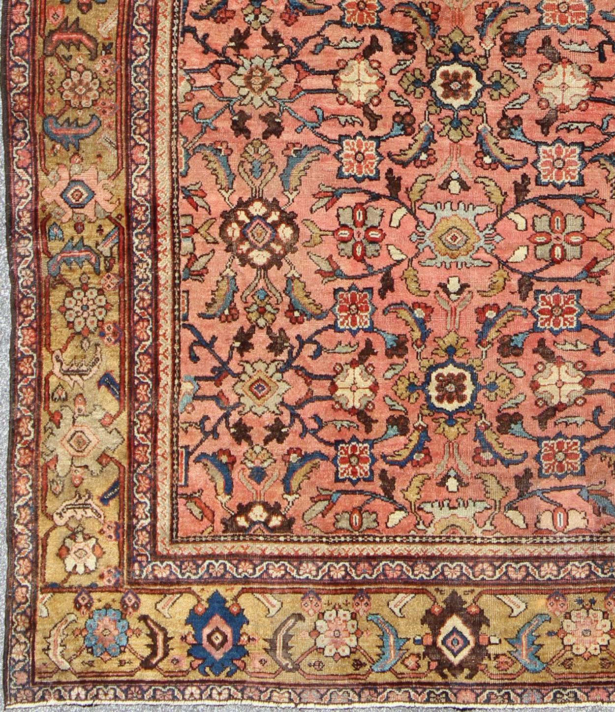 This inspiring, turn-of-the-century Sultanabad draws heavily from nature for its harmonious design. A luxurious field of salmon contains a meticulous array of interconnected floral motifs in various shades of browns, greens, gold, blues, reds, and