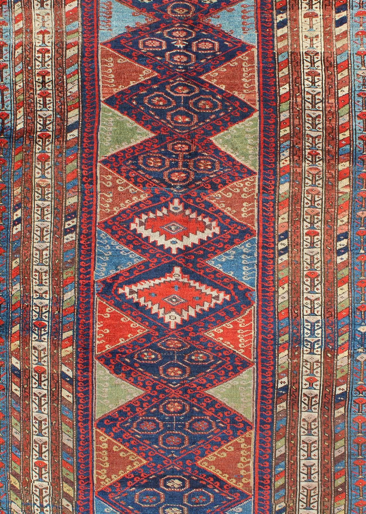 Persian Antique Kurdish Kazak with Tribal and Geometric Motifs In Blue, red & Green For Sale