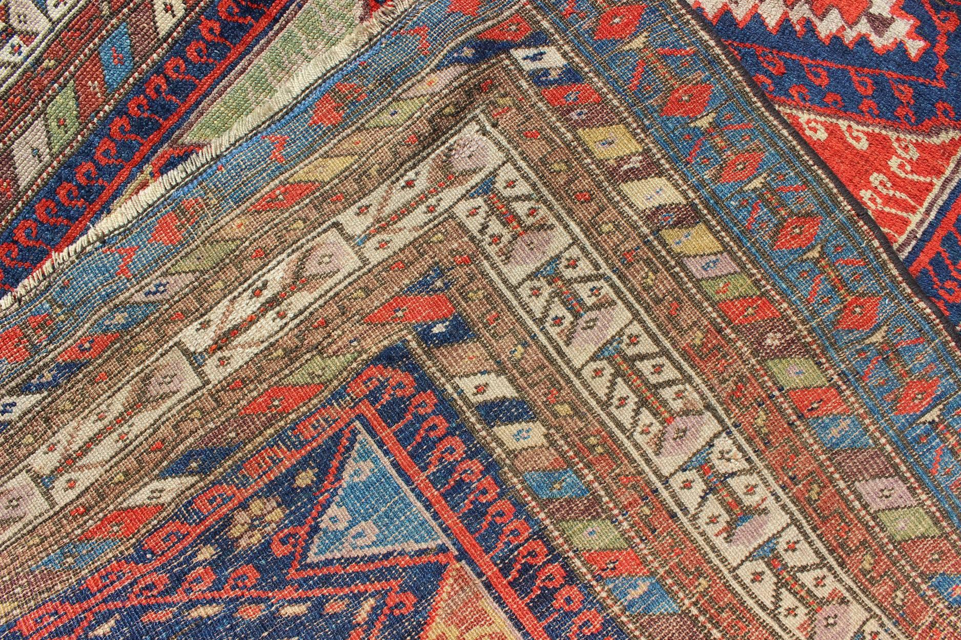 Wool Antique Kurdish Kazak with Tribal and Geometric Motifs In Blue, red & Green For Sale