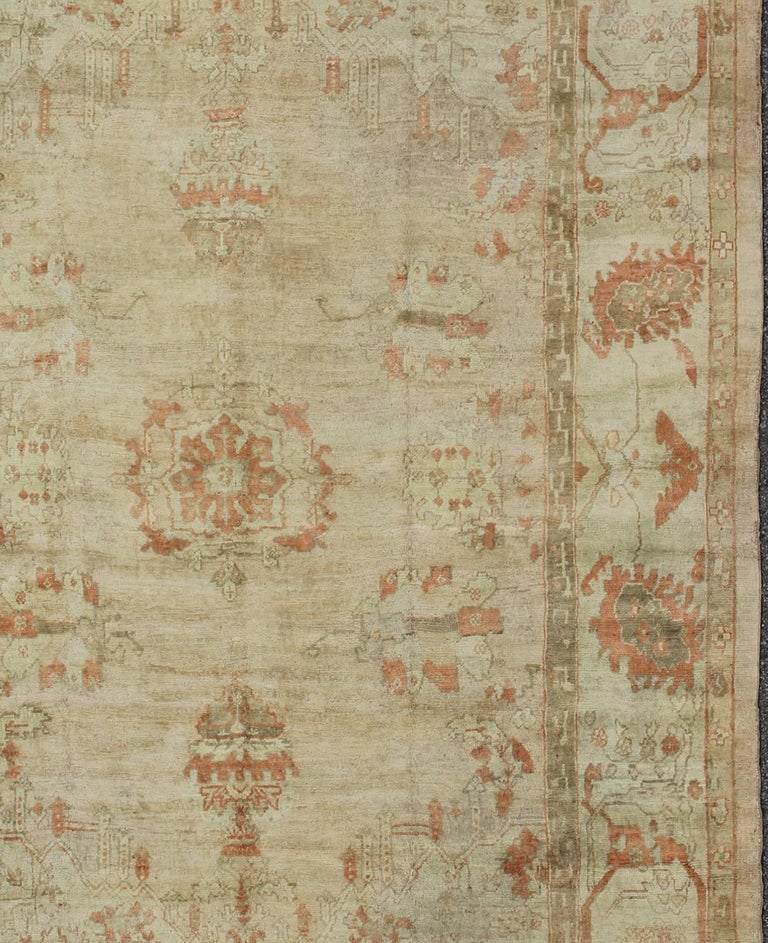 Antique Oushak Rug with Pastel Colors in Tan, Ivory, Light Green and