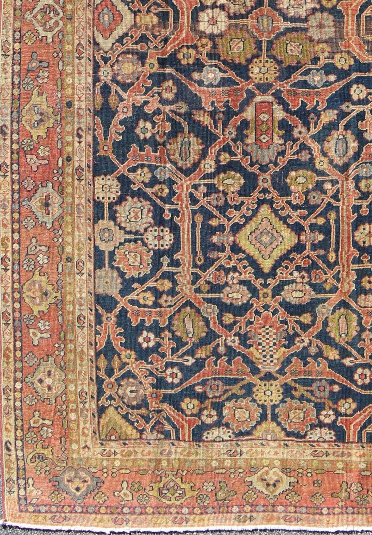 Antique Persian Sultanabad Gallery Rug with All over Design in Blue Background.
This Antique Sultanabad displays a glorious all-over design imbued with a rich palette of colors. Breathtaking flowers of various colors interweave throughout the main