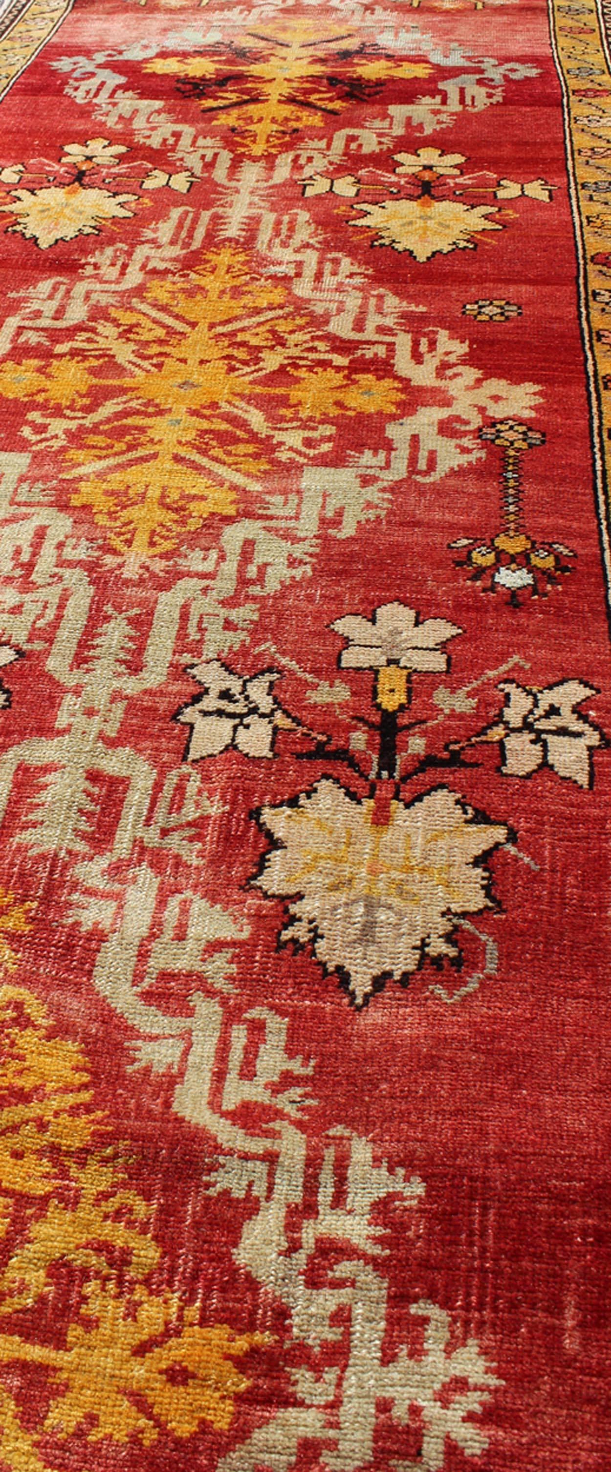 Wool Antique Turkish Oushak Runner with Tribal Medallions in Red, Orange, and Yellow For Sale