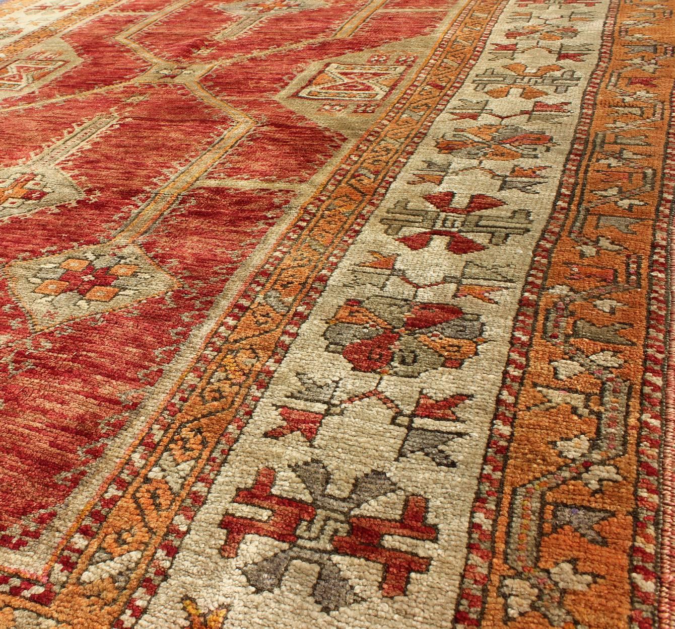 Wool Antique Turkish Oushak Rug With Geometric Design in Red, Light Green & L. Orange For Sale