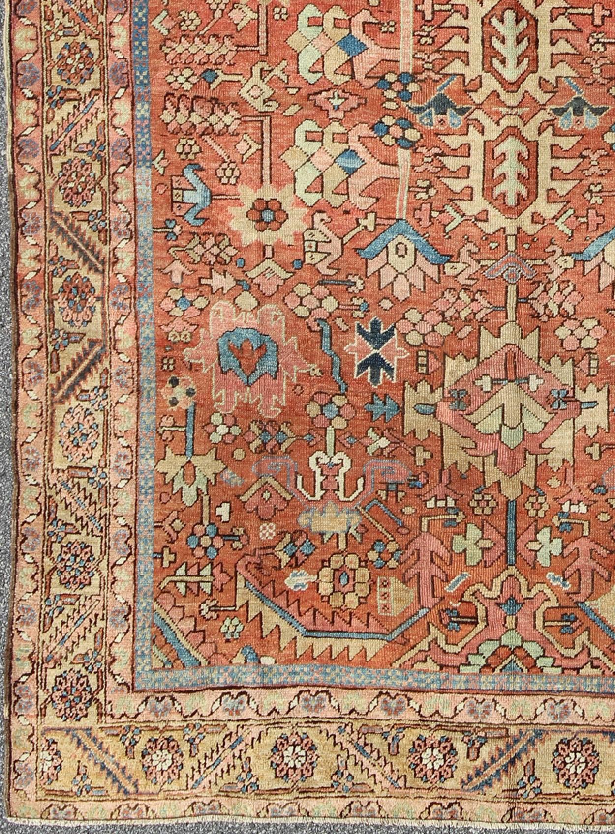 Antique All-Over Persian Heriz Rug in Faded Rust and Gold Colors
This beautiful antique Heriz-Goravan was handcrafted during the late 19th Century. The rug bears an all-over sub-geometric pattern with hints of floral motifs sprinkled throughout. A