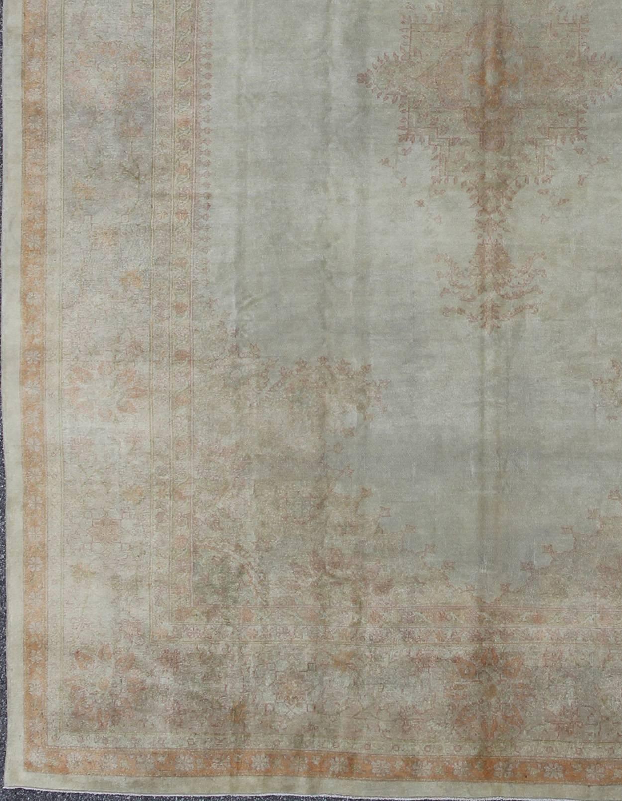 Antique Turkish Burlu Oushak Rug with Fine Weave in Muted Colors:
Measures: 10’8 x 14’5.
This stunning antique Turkish Oushak from the late 19th Century bears a remarkably sophisticated palette of soft colors such as taupe, silver, mocha and cream.