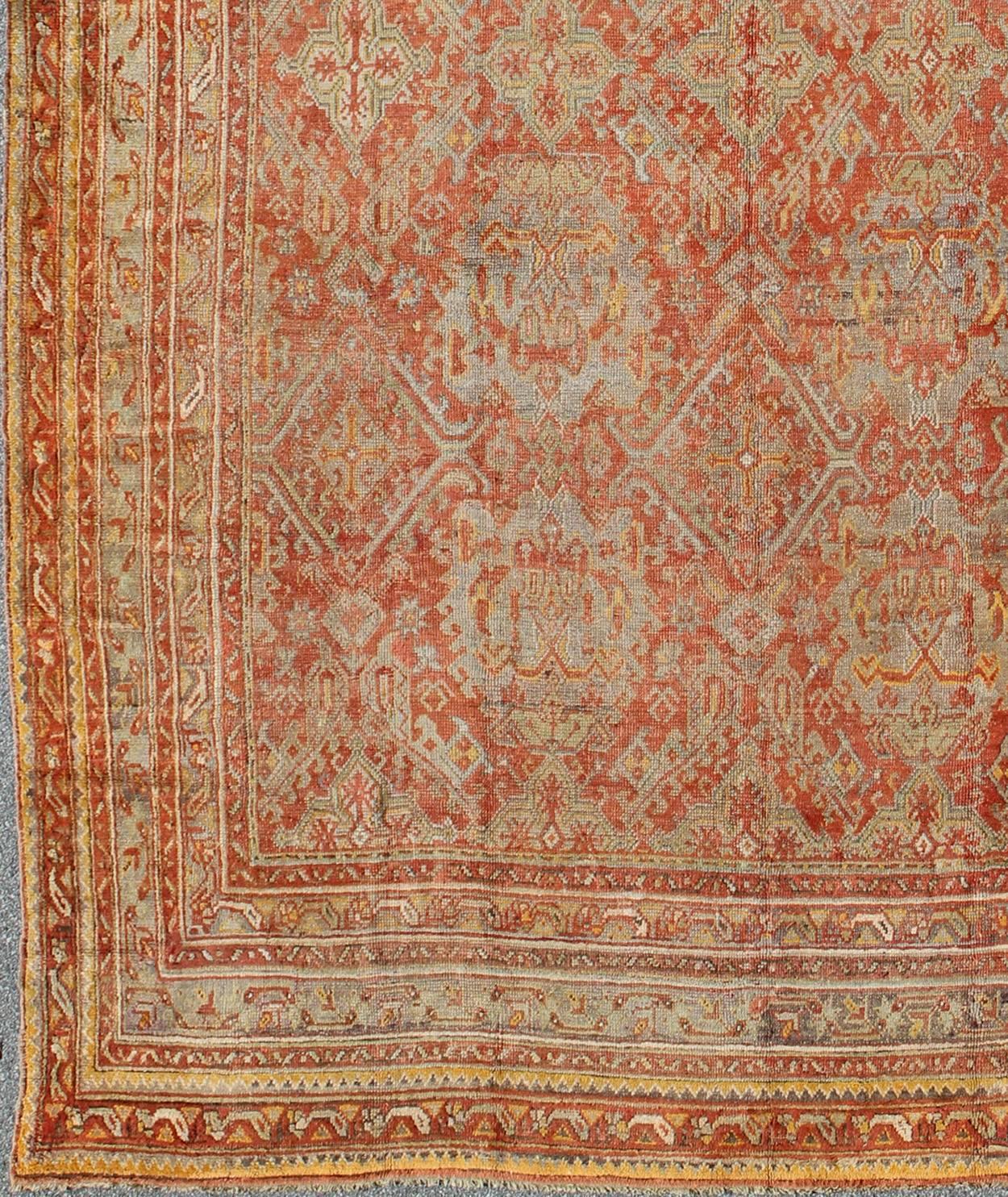 Antique Turkish Oushak Rug with Geometric Design in Soft Red, Light Blue, Yellow, Taupe and Gray.  Antique Oushak / Keivan Woven Arts / rug VR-6061, country of origin / type: Turkey / Oushak, circa Early-20th century
Measures: 12' x 17'.
This
