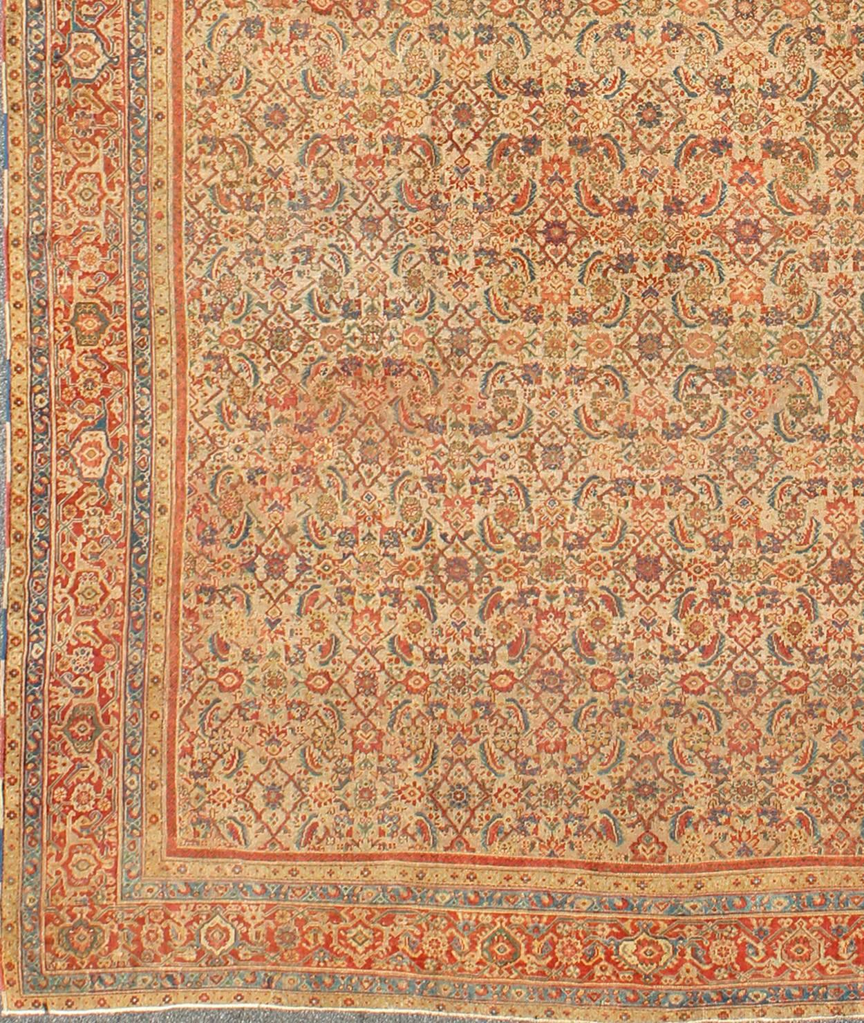 Grandiose Antique Persian Sultanabad Rug in Tan Background, Rust Red, Green, Blue and Multi colors. This highly sophisticated antique Sultanabad Mahal beautifully illustrates the complexities of turn-of-the-century Persian craftsmanship and design.