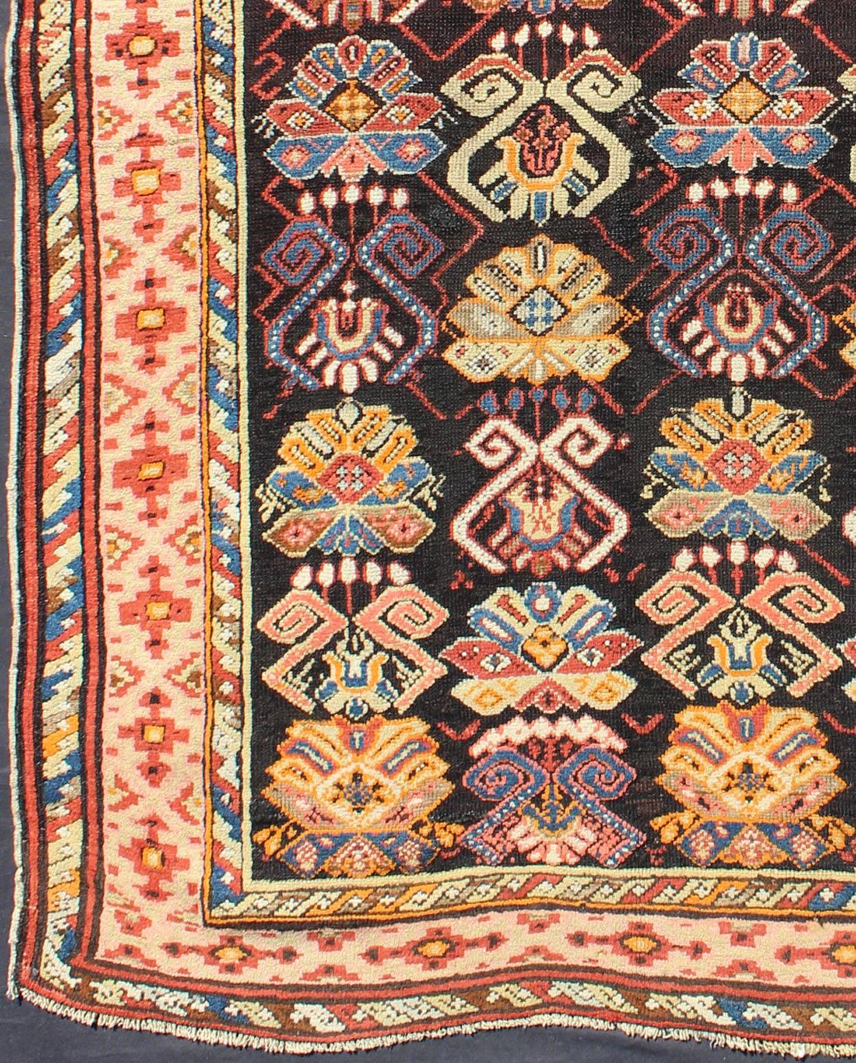 This uniquely colorful antique Caucasian carpet bears an alternating pattern of highly stylized geometric motifs within the body of the rug. A multi-tiered border with alternating geometric patterns frame the entire rug.
Measurement: 3'5 x 5'.