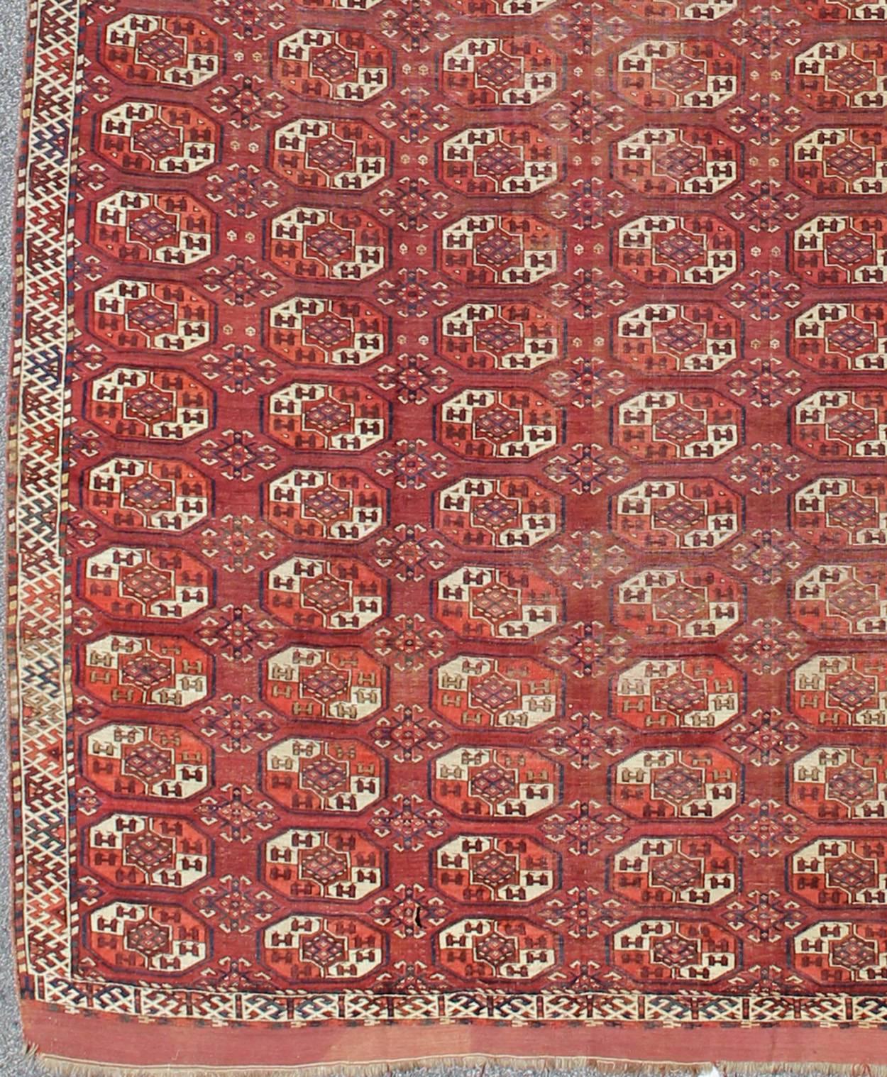Extremely large antique gallery rug with red field and repeating Medallion design. Rug / J10-1105. Long Tekke gallery size.
This rare antique Tekke carpet displays warm and delightful red. The field consists motifs with red, orange, medium blue,