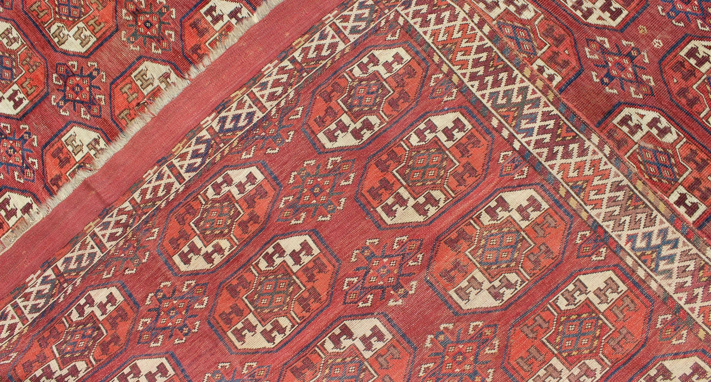 Wool Extremely Large Antique Tekke Rug with Red Field and Repeating Medallion Design