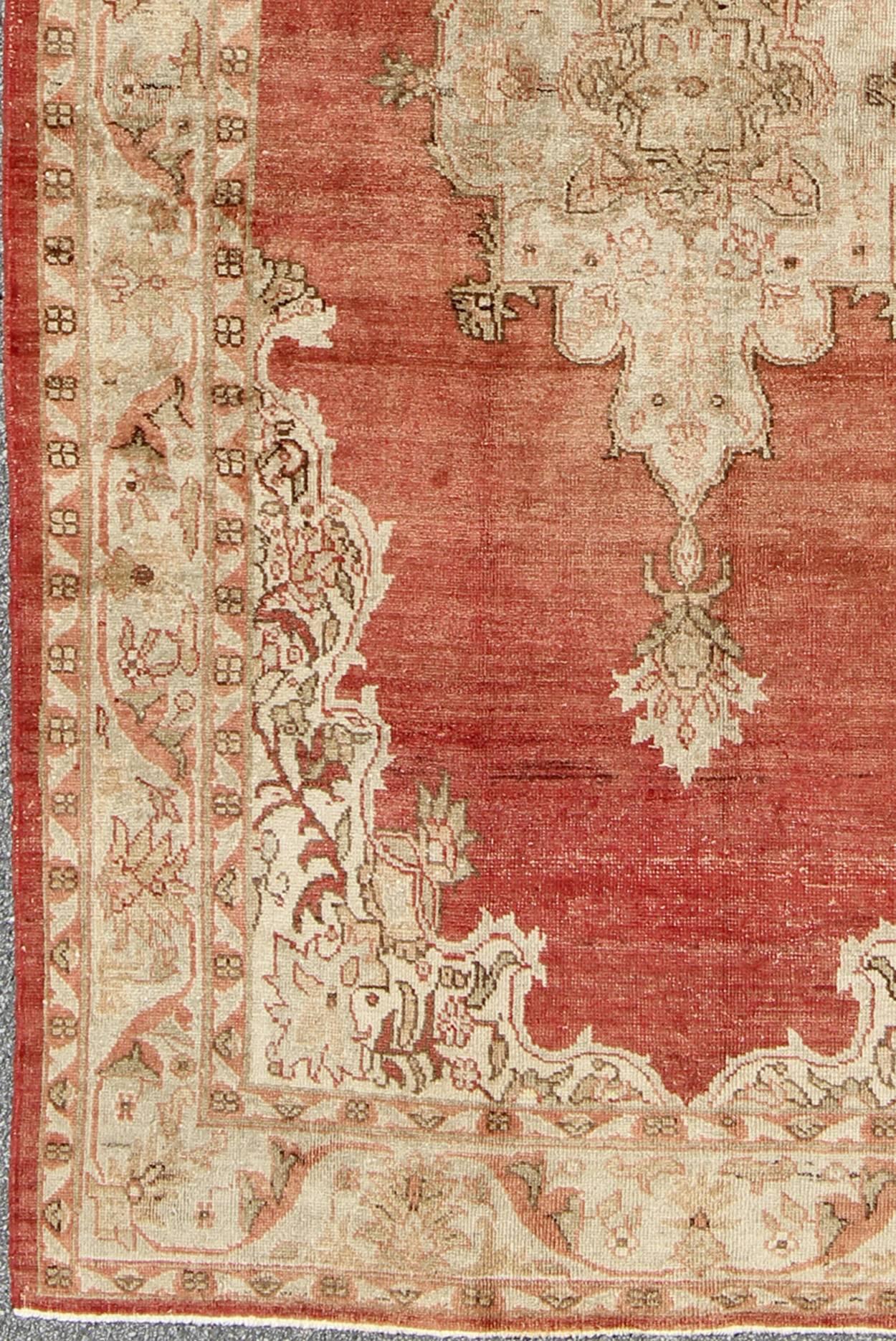 Antique Turkish medallion Oushak rug in soft red, taupe and light green. Rug/NA-41953, 1930's Oushak antique Turkish rug in soft red background, taupe & pale green.

This beautiful antique Turkish Oushak carpet bears a lovely stretched central