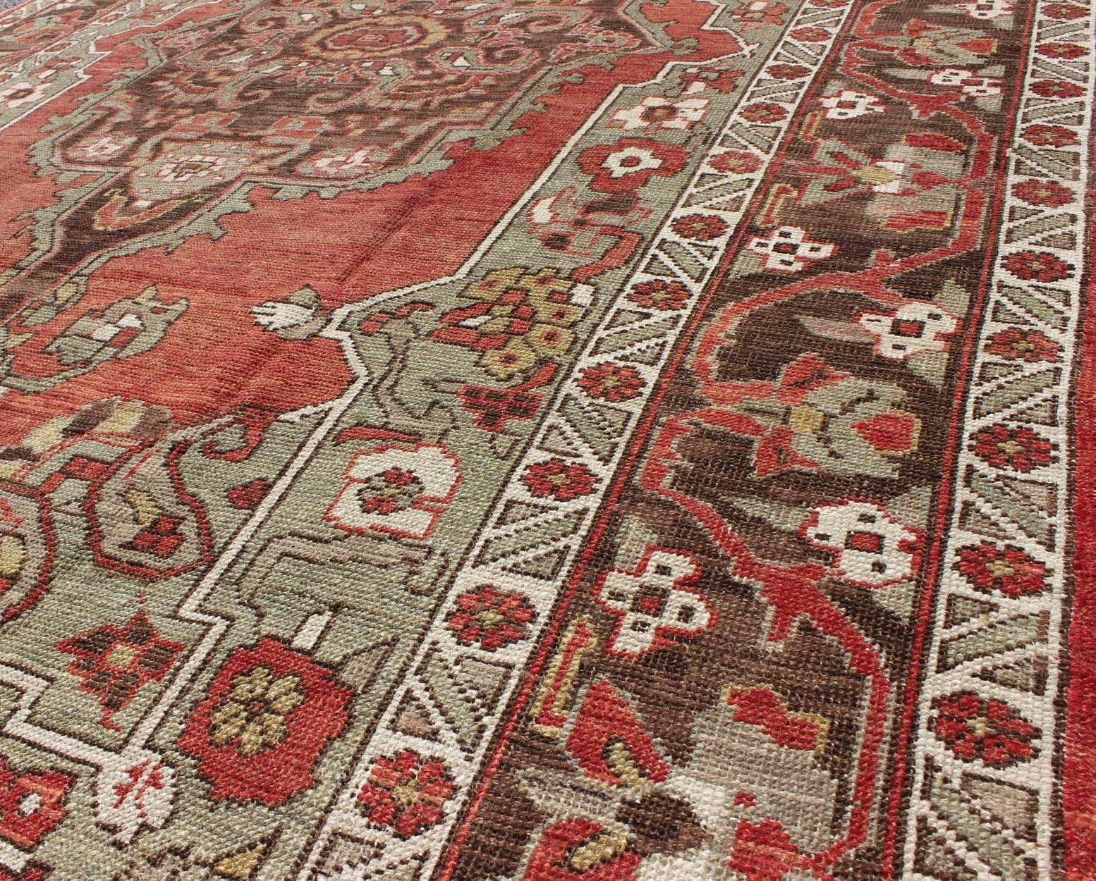 Wool Antique Turkish Oushak Carpet with Medallion in Soft Red, Green and Brown  For Sale