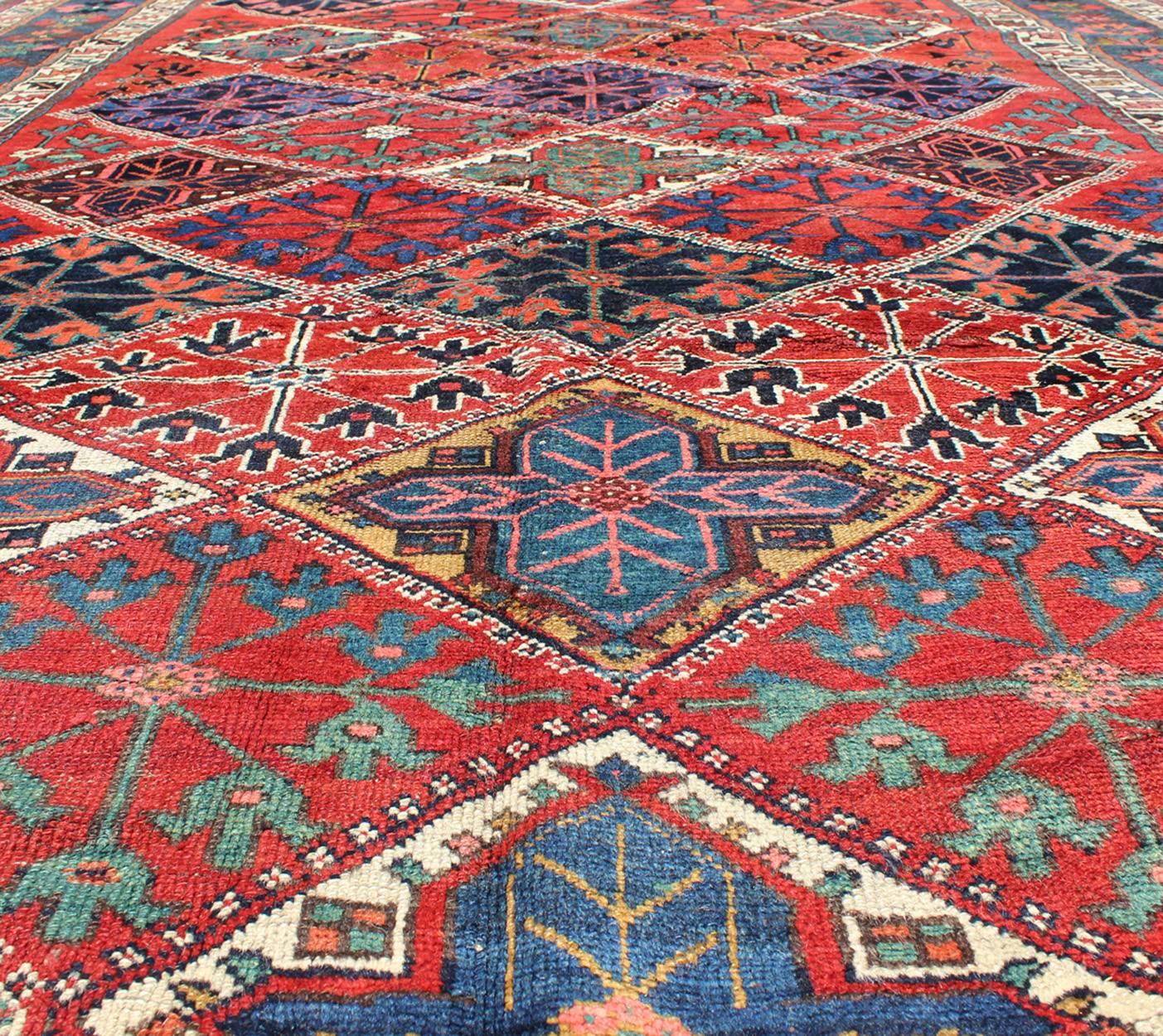 Tribal Antique Persian Qashqai Rug with Tulips, Diamond Patterns and Star Motifs For Sale