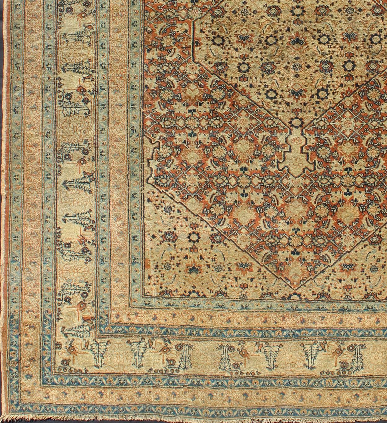 Antique Persian Tabriz Haj Jalili Fine Rug in Earth tones, Red Brown Background. CN-90801, 
This antique Persian Tabriz Haj Jalili rug features a sophisticated design and a unique color combination in Light cream and Persian blue and Herati design